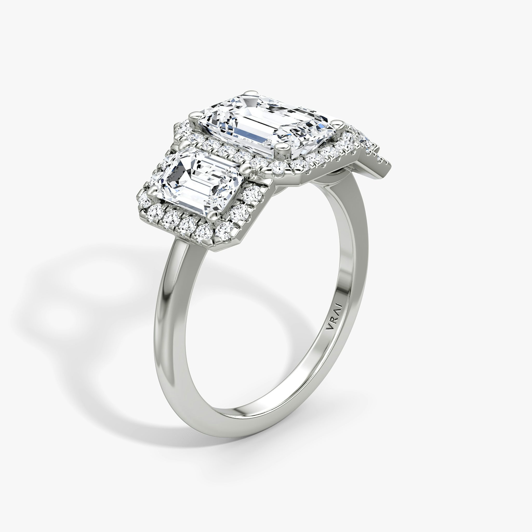 The Three Stone Halo | Emerald | Platinum | bandAccent: Plain | sideStoneCarat: 0.50ct | diamondOrientation: vertical | caratWeight: other