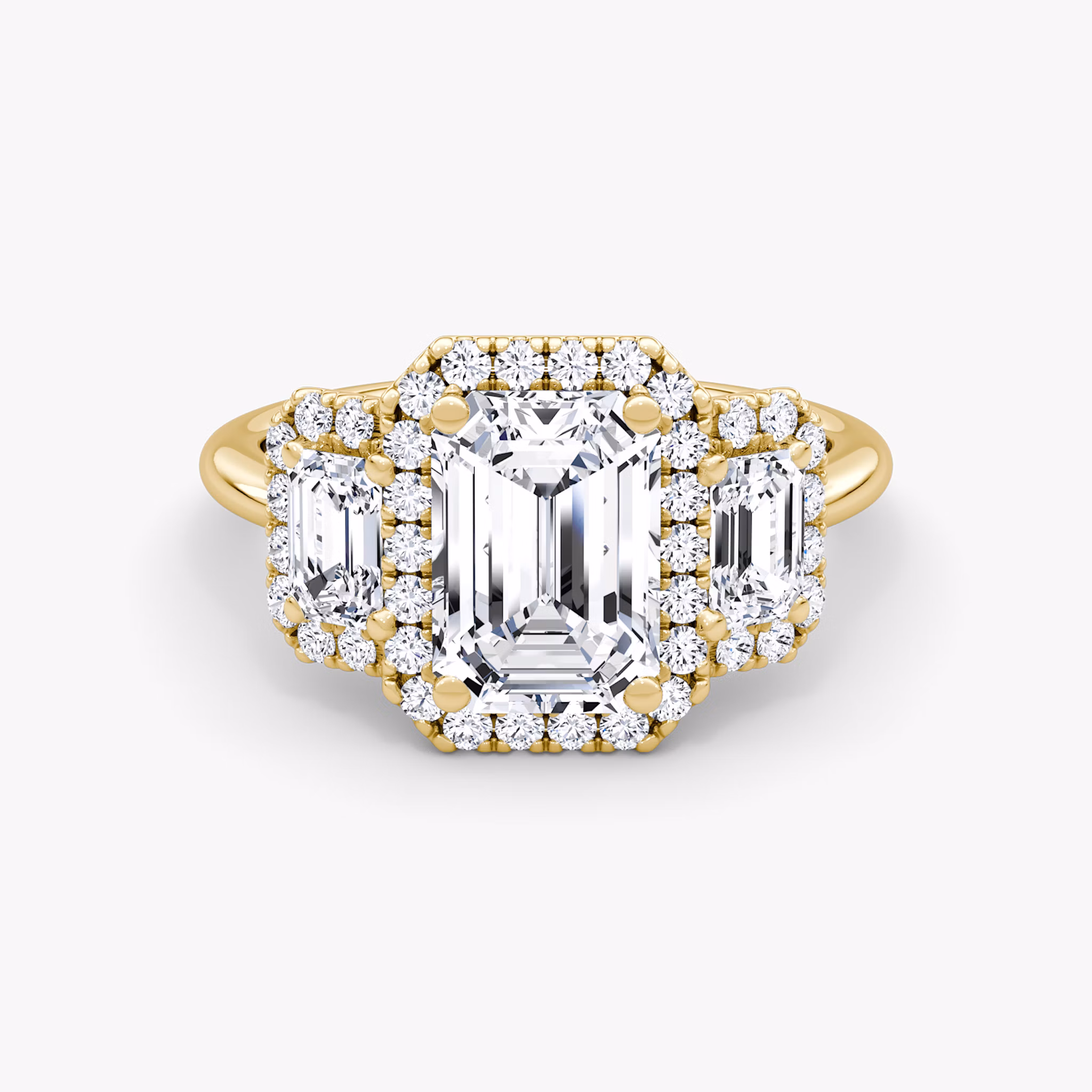 The Three Stone Halo Emerald Yellow Gold Engagement Ring.