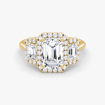 The Three Stone Halo Emerald Yellow Gold Engagement Ring.