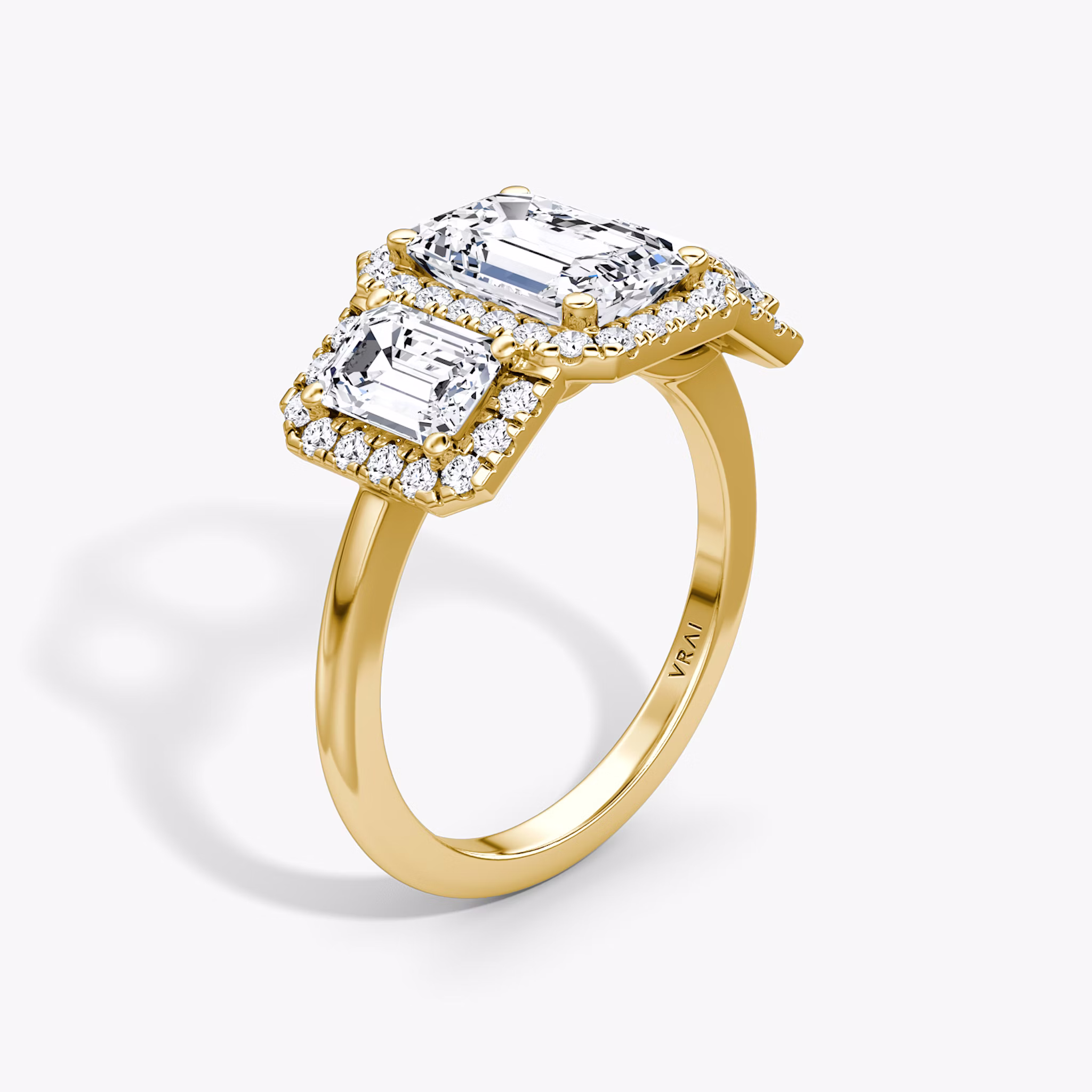 The Three Stone Halo | Emerald | 18k | Yellow Gold | bandAccent: Plain | sideStoneCarat: 0.50ct | diamondOrientation: vertical | caratWeight: other