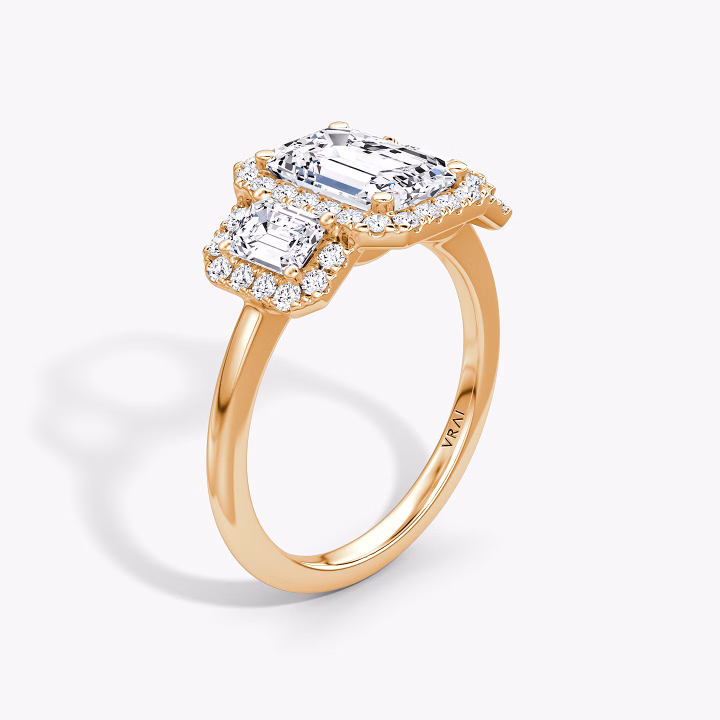 The Three Stone Halo | Emerald | 14k | Rose Gold | bandAccent: Plain | sideStoneCarat: 0.25ct | diamondOrientation: vertical | caratWeight: other