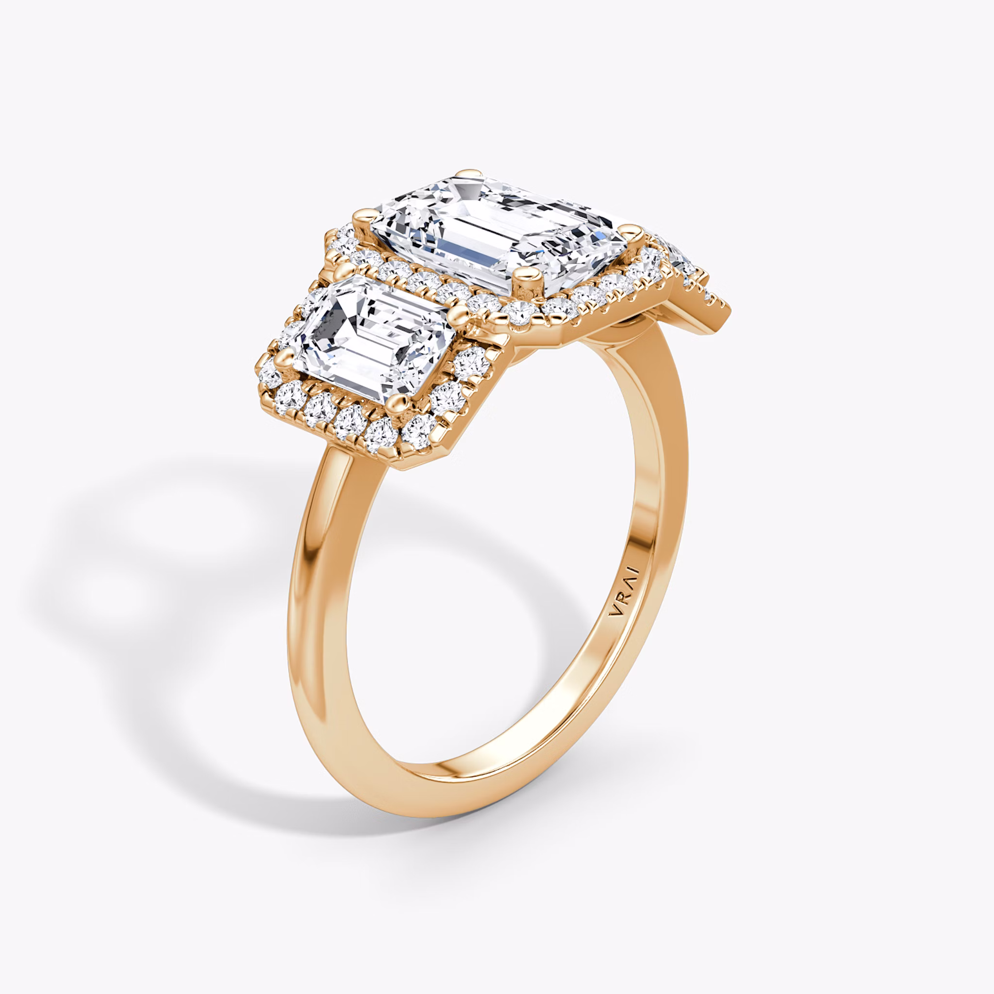 The Three Stone Halo | Emerald | 14k | Rose Gold | bandAccent: Plain | sideStoneCarat: 0.50ct | diamondOrientation: vertical | caratWeight: other