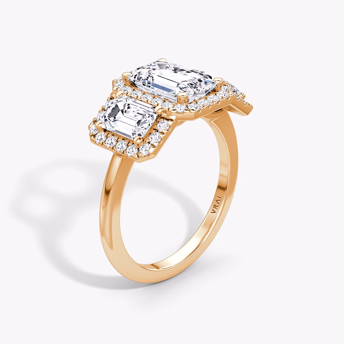 The Three Stone Halo | Emerald | 14k | Rose Gold | bandAccent: Plain | sideStoneCarat: 0.50ct | diamondOrientation: vertical | caratWeight: other