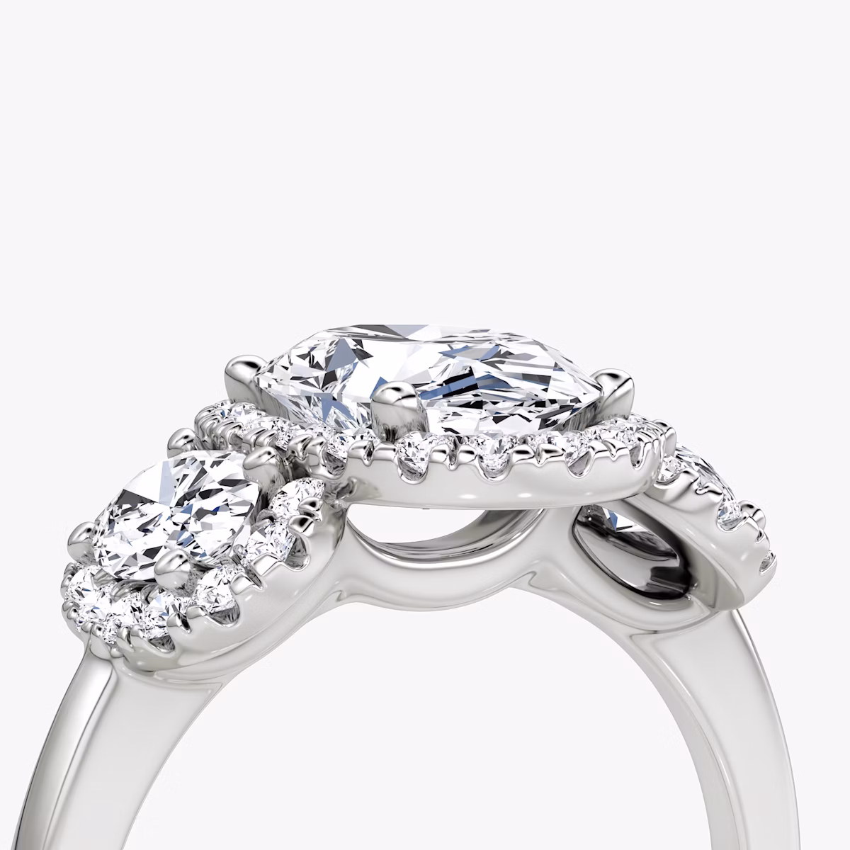 The Three Stone Halo | Oval | Platinum | bandAccent: Plain | sideStoneCarat: 0.25ct | diamondOrientation: vertical | caratWeight: other