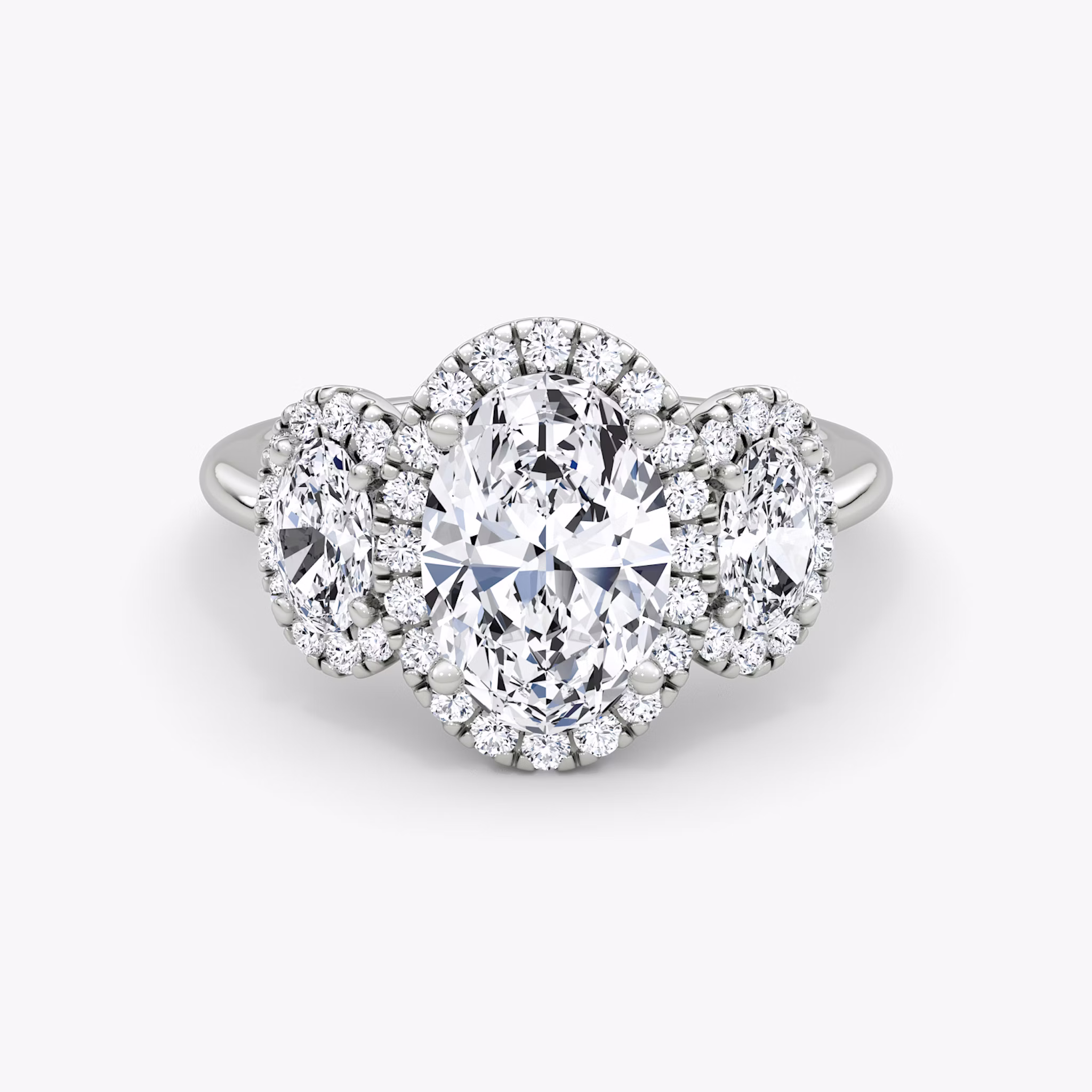 The Three Stone Halo | Oval | Platinum | bandAccent: Plain | sideStoneCarat: 0.25ct | diamondOrientation: vertical | caratWeight: other
