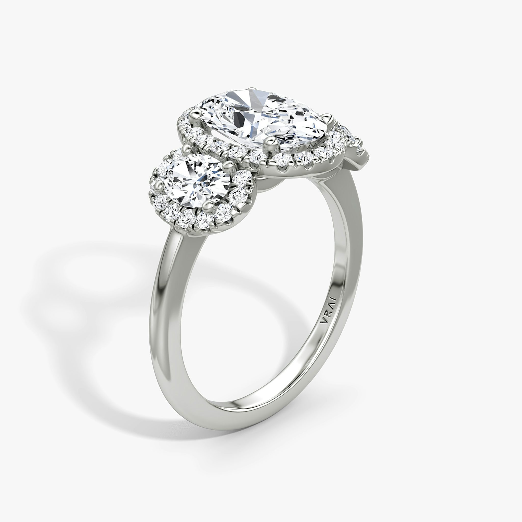 The Three Stone Halo | Oval | Platinum | bandAccent: Plain | sideStoneCarat: 0.25ct | diamondOrientation: vertical | caratWeight: other