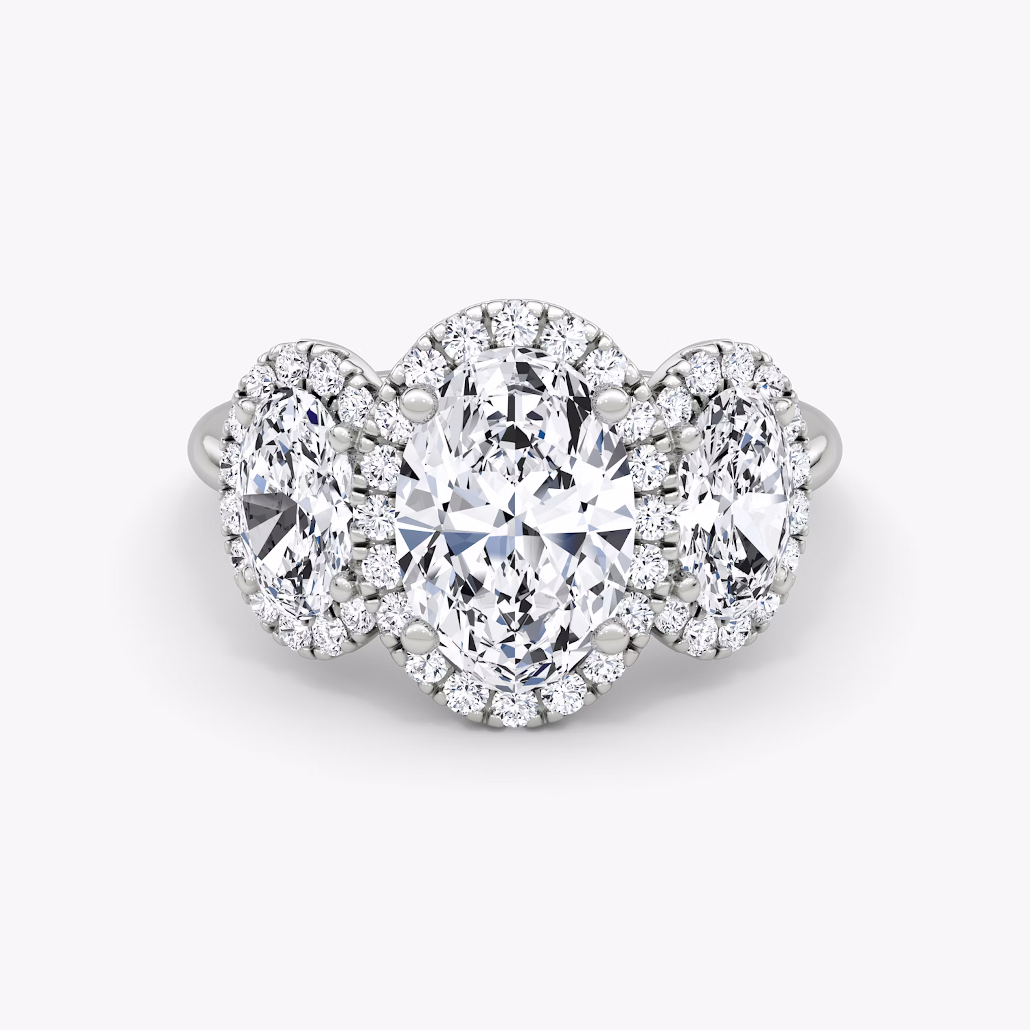 The Three Stone Halo | Oval | Platinum | bandAccent: Plain | sideStoneCarat: 0.50ct | diamondOrientation: vertical | caratWeight: other