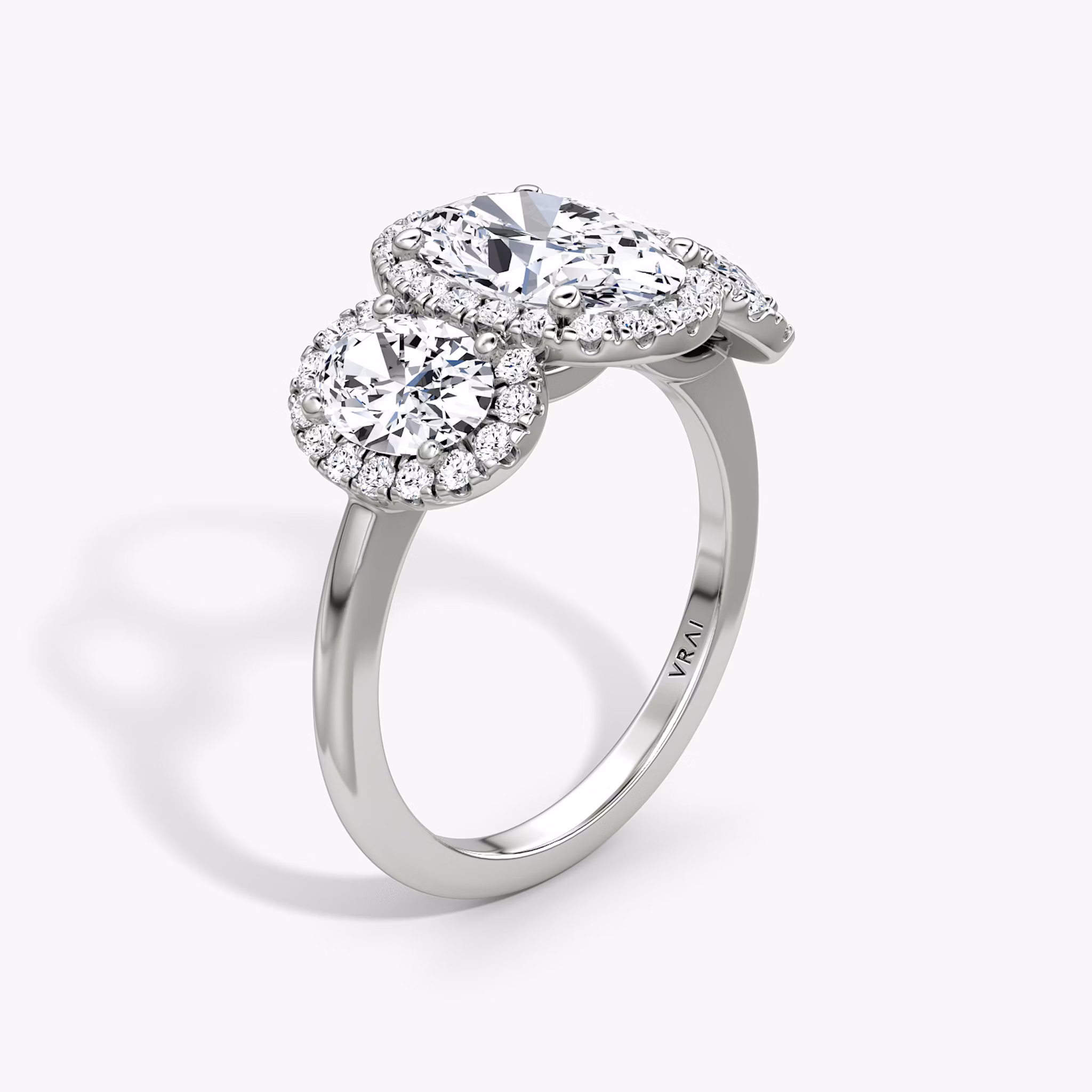The Three Stone Halo | Oval | Platinum | bandAccent: Plain | sideStoneCarat: 0.50ct | diamondOrientation: vertical | caratWeight: other