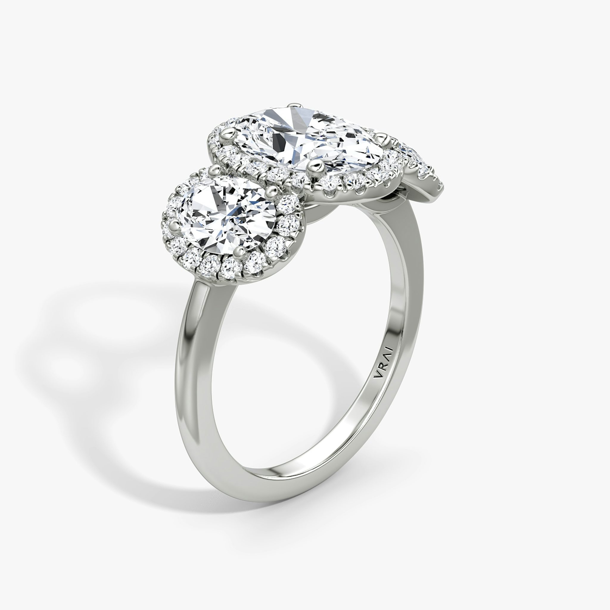 The Three Stone Halo | Oval | Platinum | bandAccent: Plain | sideStoneCarat: 0.50ct | diamondOrientation: vertical | caratWeight: other