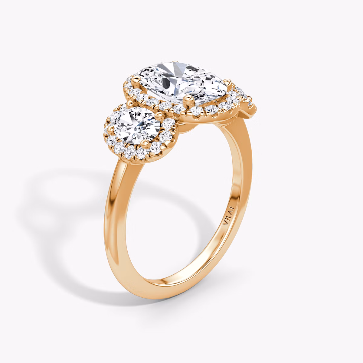 The Three Stone Halo | Oval | 14k | Rose Gold | bandAccent: Plain | sideStoneCarat: 0.25ct | diamondOrientation: vertical | caratWeight: other