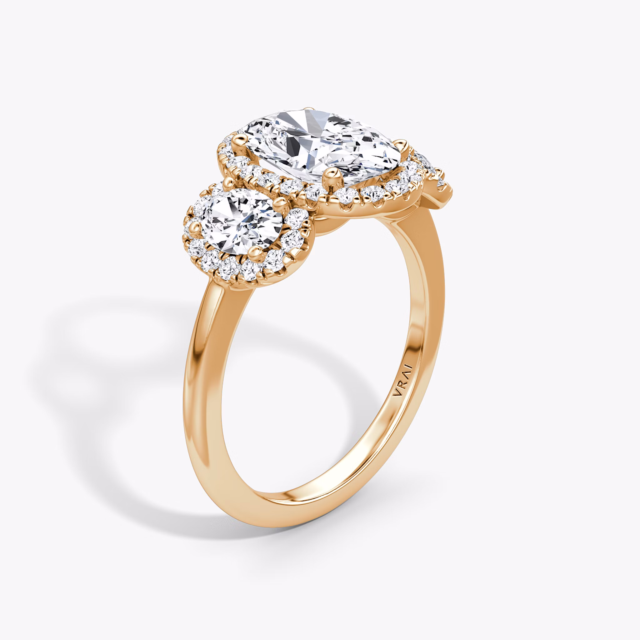 The Three Stone Halo | Oval | 14k | Rose Gold | bandAccent: Plain | sideStoneCarat: 0.25ct | diamondOrientation: vertical | caratWeight: other