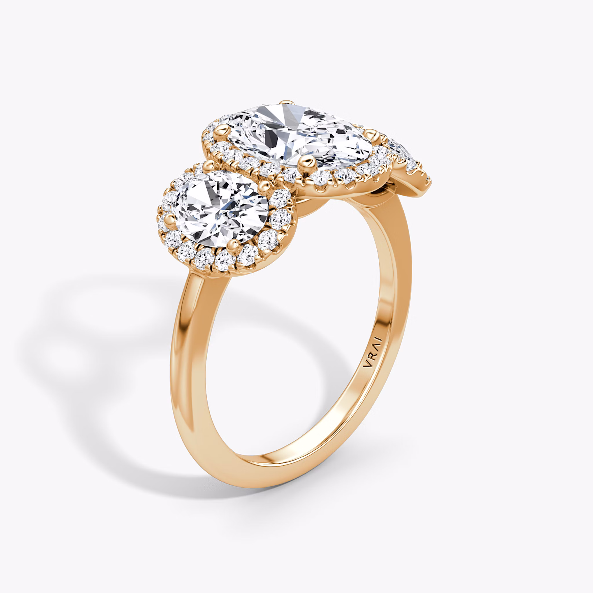 The Three Stone Halo | Oval | 14k | Rose Gold | bandAccent: Plain | sideStoneCarat: 0.50ct | diamondOrientation: vertical | caratWeight: other