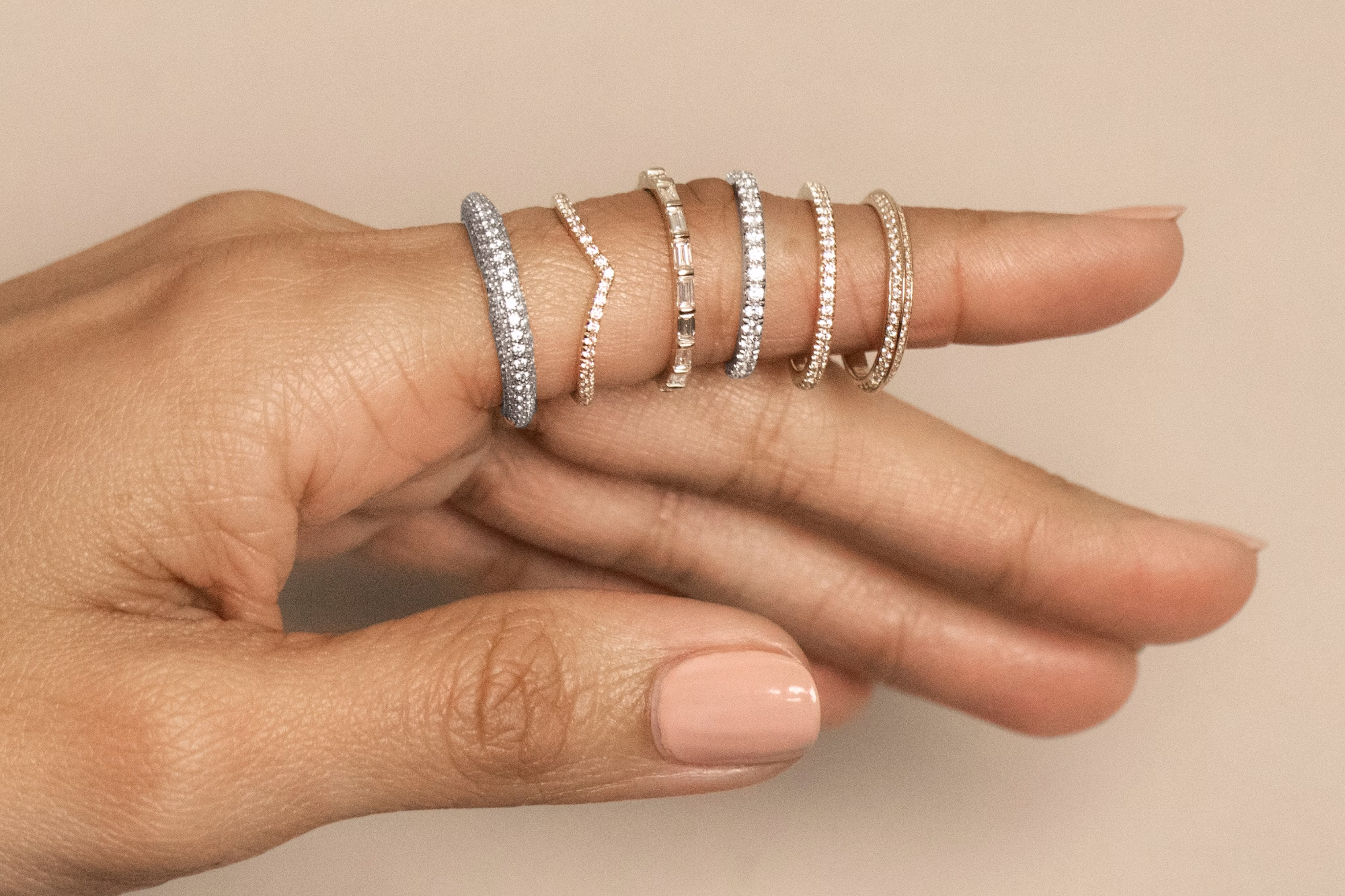 Close-up of small-sized diamond rings in size 5, displayed in a row for comparison and sizing reference on a product page.