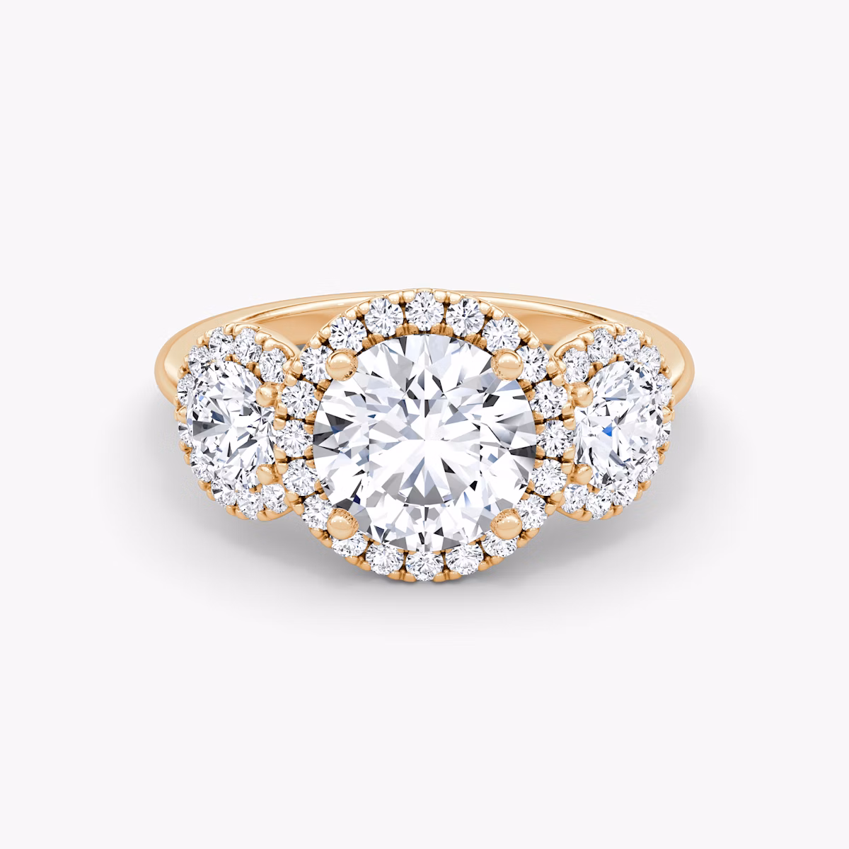 The Three Stone Halo | Round Brilliant | 14k | Rose Gold | bandAccent: Plain | caratWeight: other | sideStoneCarat: 0.25ct | diamondOrientation: vertical