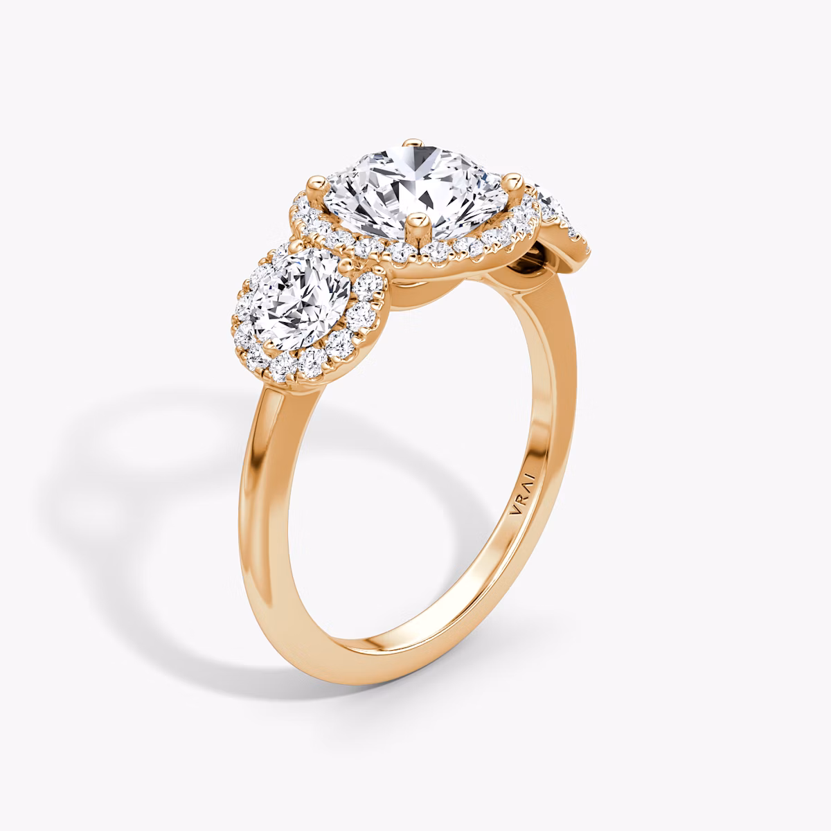 The Three Stone Halo | Round Brilliant | 14k | Rose Gold | bandAccent: Plain | caratWeight: other | sideStoneCarat: 0.25ct | diamondOrientation: vertical
