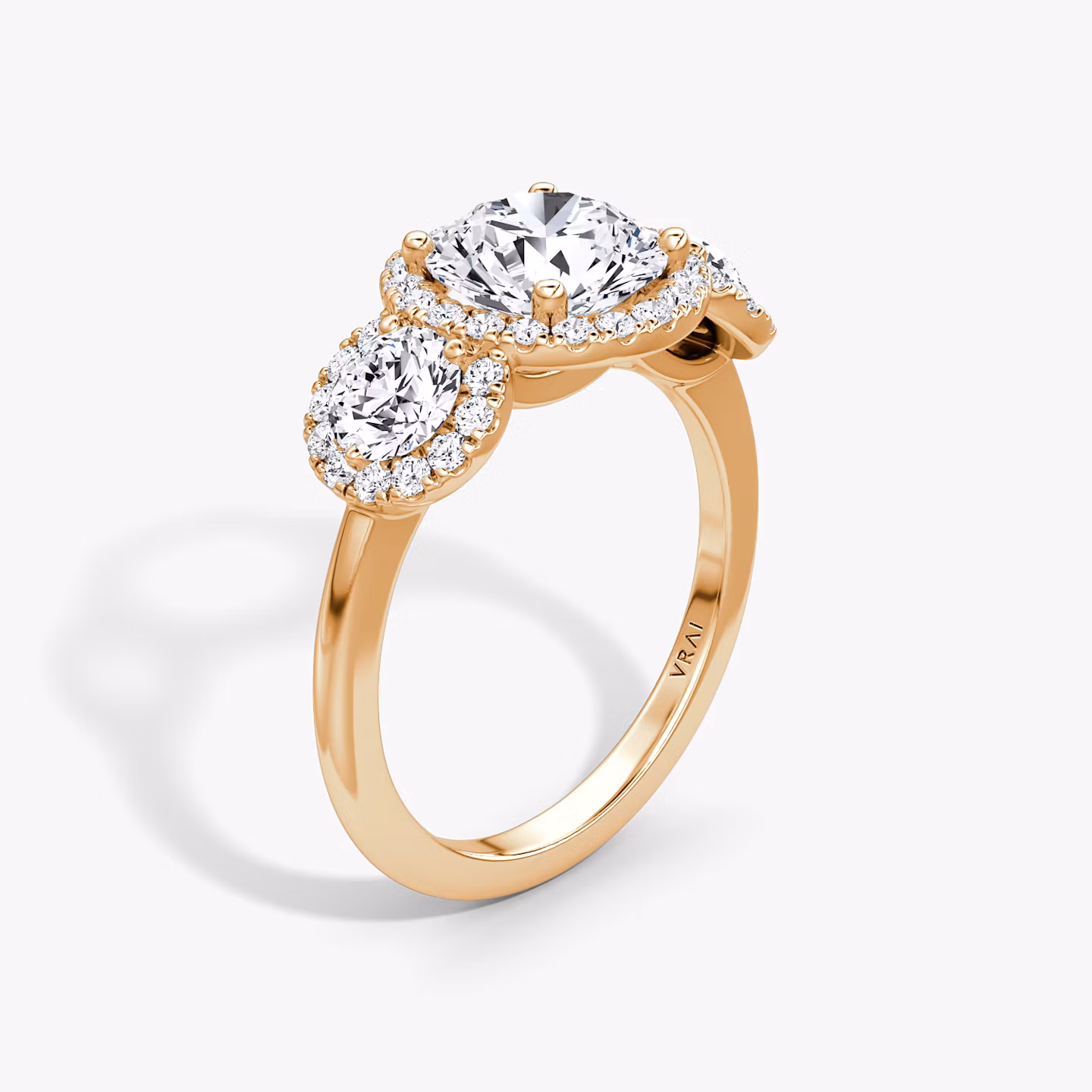 The Three Stone Halo | Round Brilliant | 14k | Rose Gold | bandAccent: Plain | caratWeight: 1.0ct | sideStoneCarat: 0.25ct | diamondOrientation: vertical