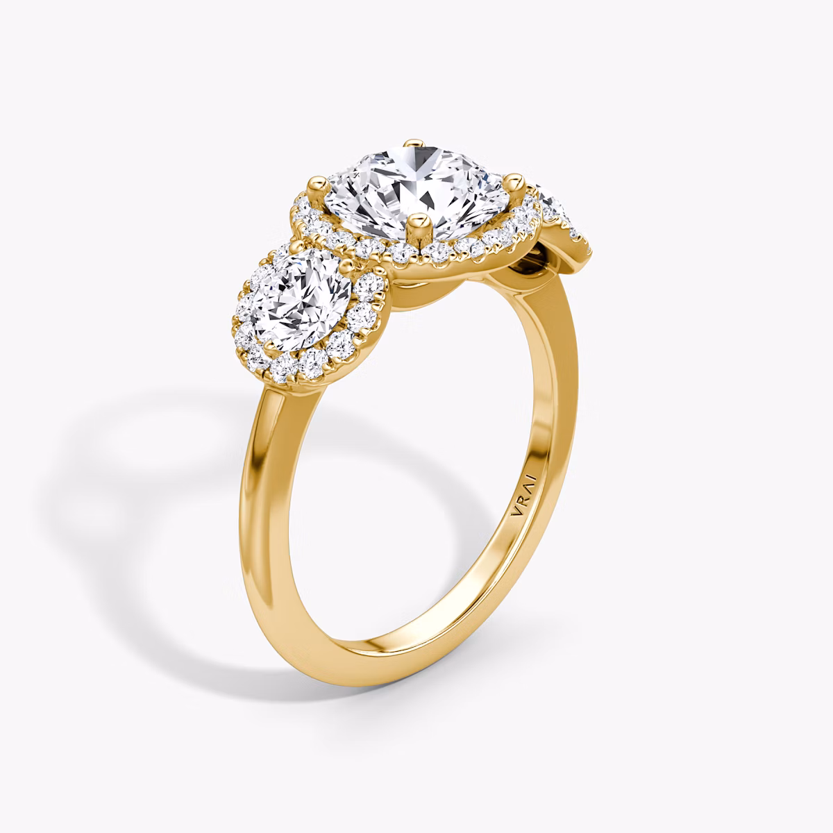 The Three Stone Halo | Round Brilliant | 18k | Yellow Gold | bandAccent: Plain | caratWeight: 1.0ct | sideStoneCarat: 0.25ct | diamondOrientation: vertical