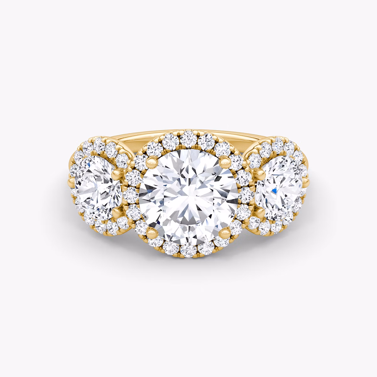 The Three Stone Halo | Round Brilliant | 18k | Yellow Gold | bandAccent: Plain | caratWeight: other | sideStoneCarat: 0.50ct | diamondOrientation: vertical