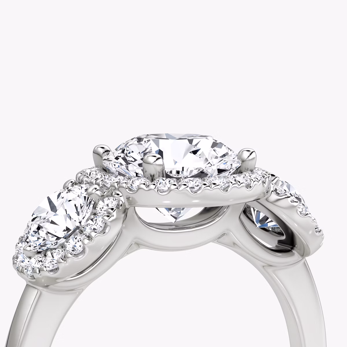The Three Stone Halo | Round Brilliant | Platinum | bandAccent: Plain | caratWeight: other | sideStoneCarat: 0.25ct | diamondOrientation: vertical