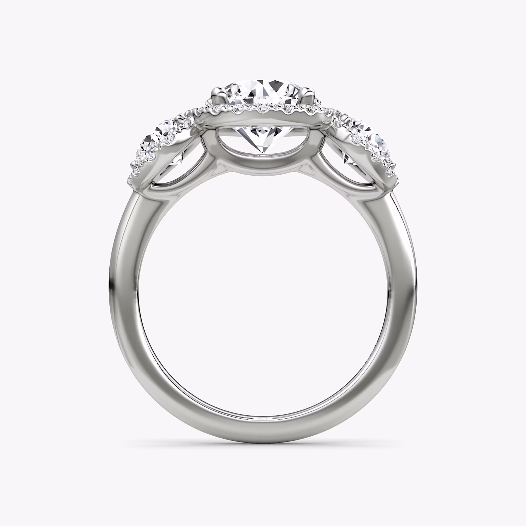 The Three Stone Halo | Round Brilliant | 18k | White Gold | bandAccent: Plain | caratWeight: other | sideStoneCarat: 0.25ct | diamondOrientation: vertical