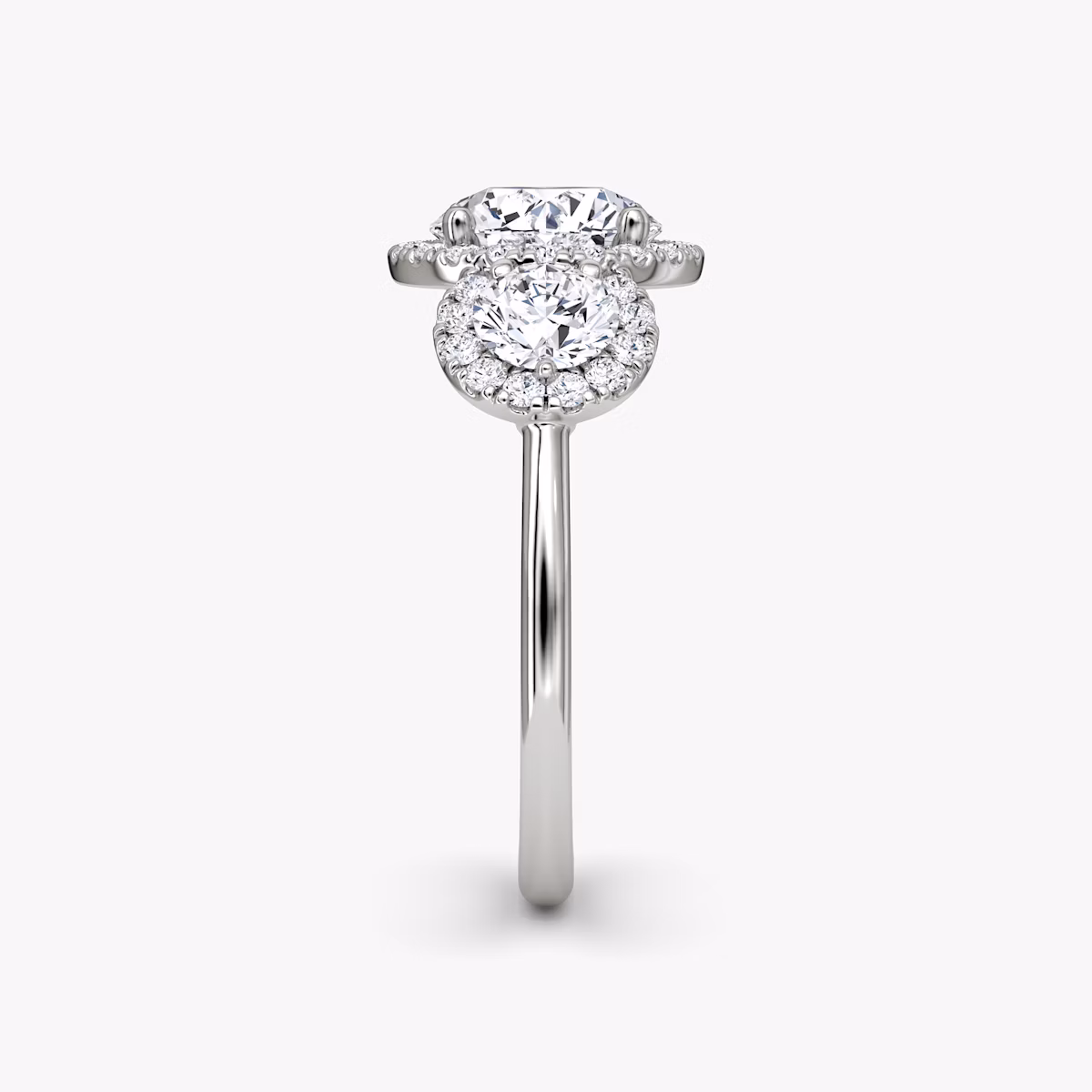 The Three Stone Halo | Round Brilliant | Platinum | bandAccent: Plain | caratWeight: other | sideStoneCarat: 0.25ct | diamondOrientation: vertical