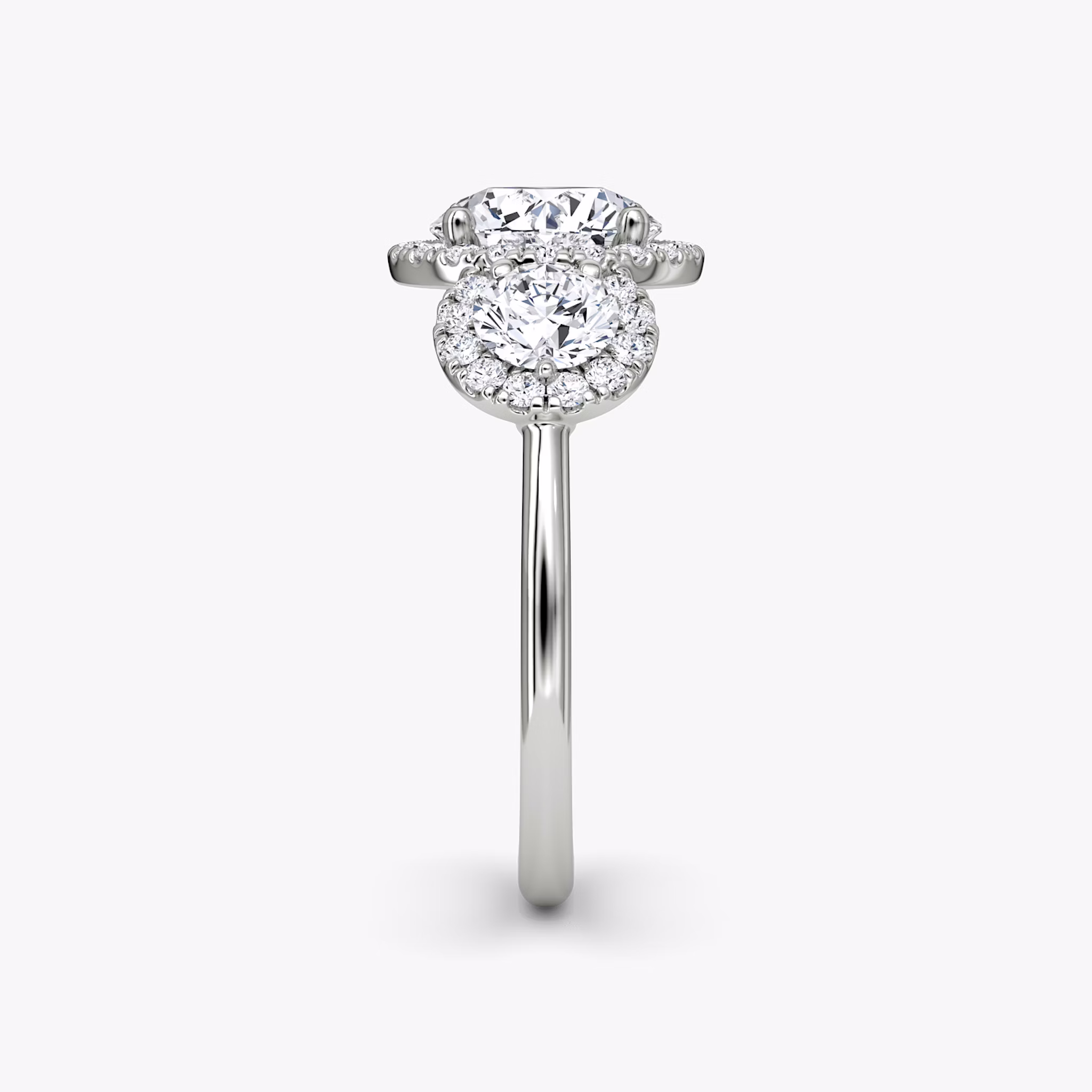 The Three Stone Halo | Round Brilliant | 18k | White Gold | bandAccent: Plain | caratWeight: other | sideStoneCarat: 0.25ct | diamondOrientation: vertical