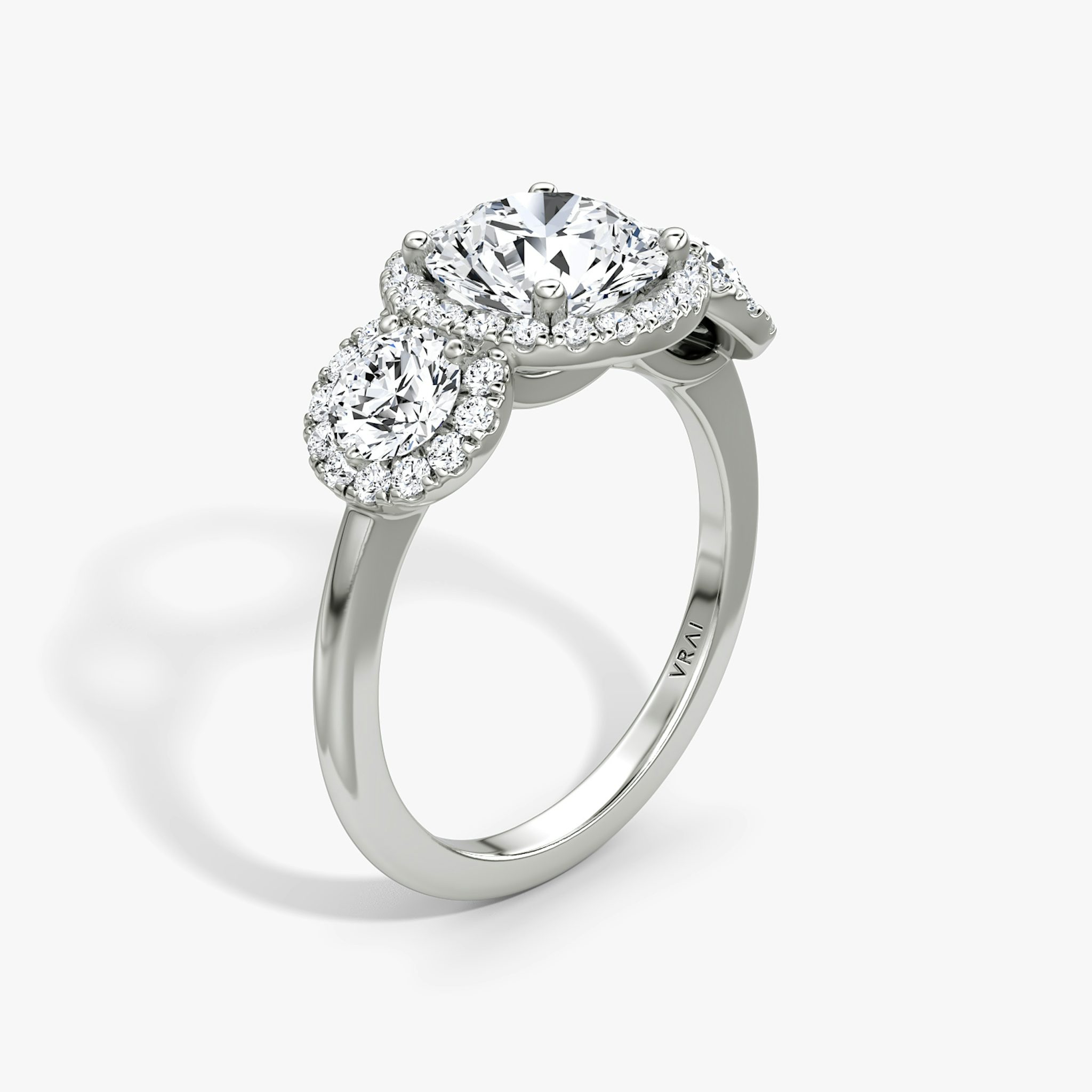 The Three Stone Halo | Round Brilliant | 18k | White Gold | bandAccent: Plain | caratWeight: other | sideStoneCarat: 0.25ct | diamondOrientation: vertical