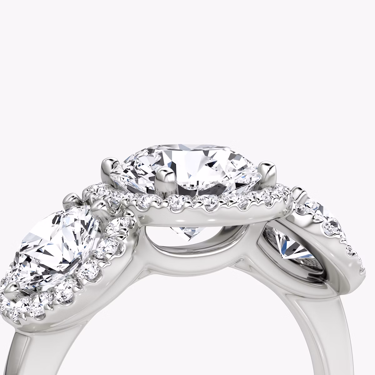 The Three Stone Halo | Round Brilliant | Platinum | bandAccent: Plain | caratWeight: 1.0ct | sideStoneCarat: 0.50ct | diamondOrientation: vertical