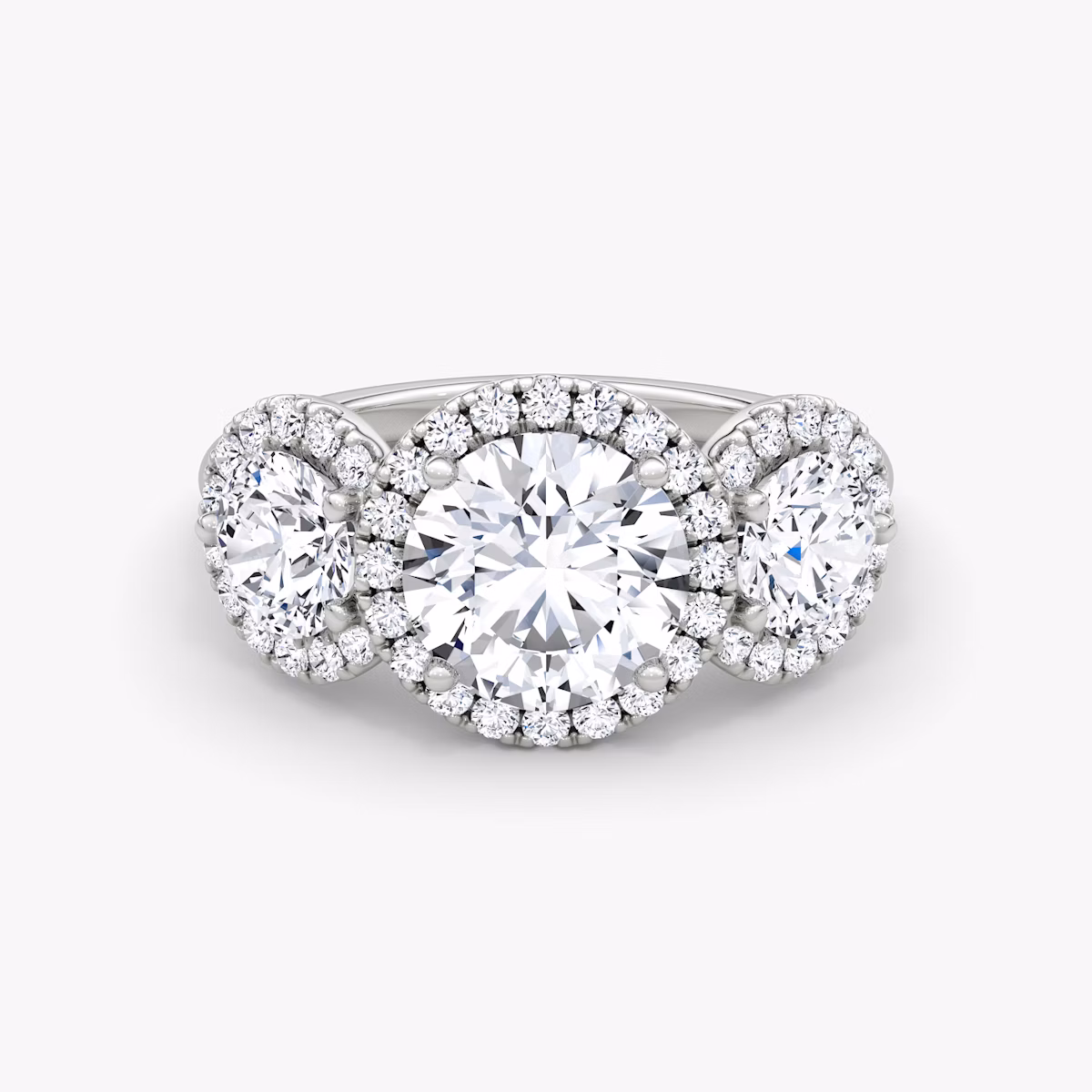 The Three Stone Halo | Round Brilliant | Platinum | bandAccent: Plain | caratWeight: 1.0ct | sideStoneCarat: 0.50ct | diamondOrientation: vertical