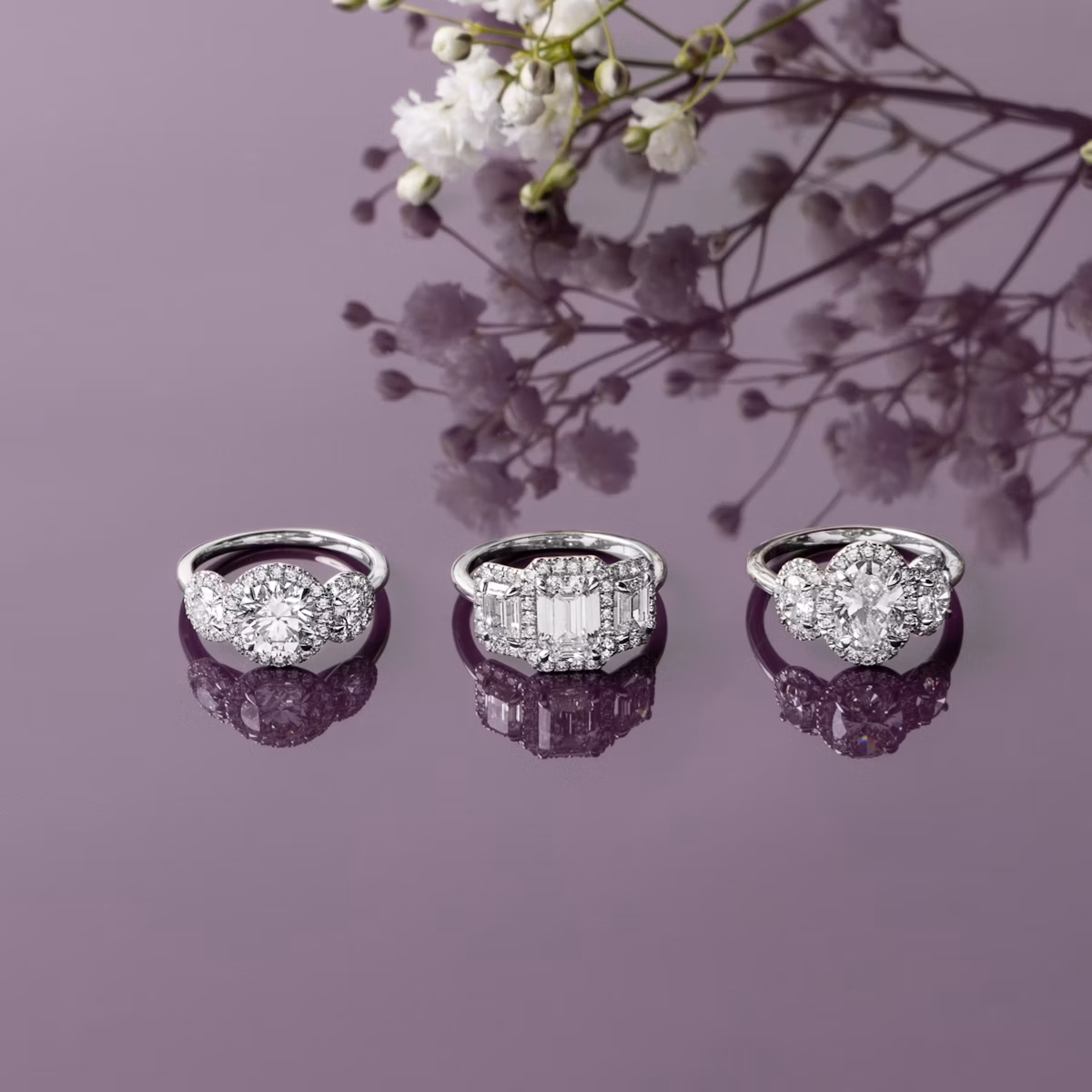 The Three Stone Halo | Round Brilliant | Platinum | bandAccent: Plain | caratWeight: other | sideStoneCarat: 0.25ct | diamondOrientation: vertical