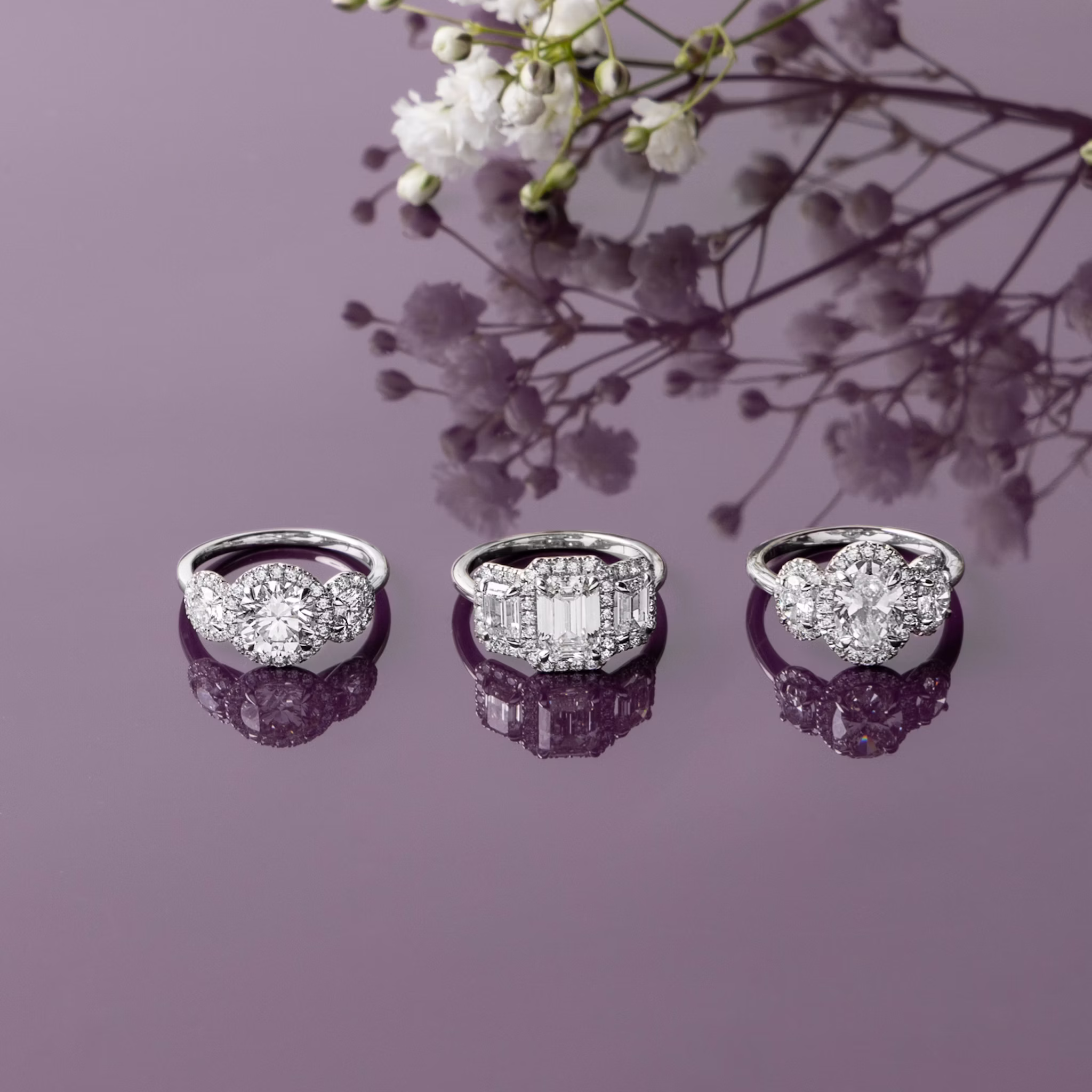 The Three Stone Halo | Oval | Platinum | bandAccent: Plain | sideStoneCarat: 0.25ct | diamondOrientation: vertical | caratWeight: other