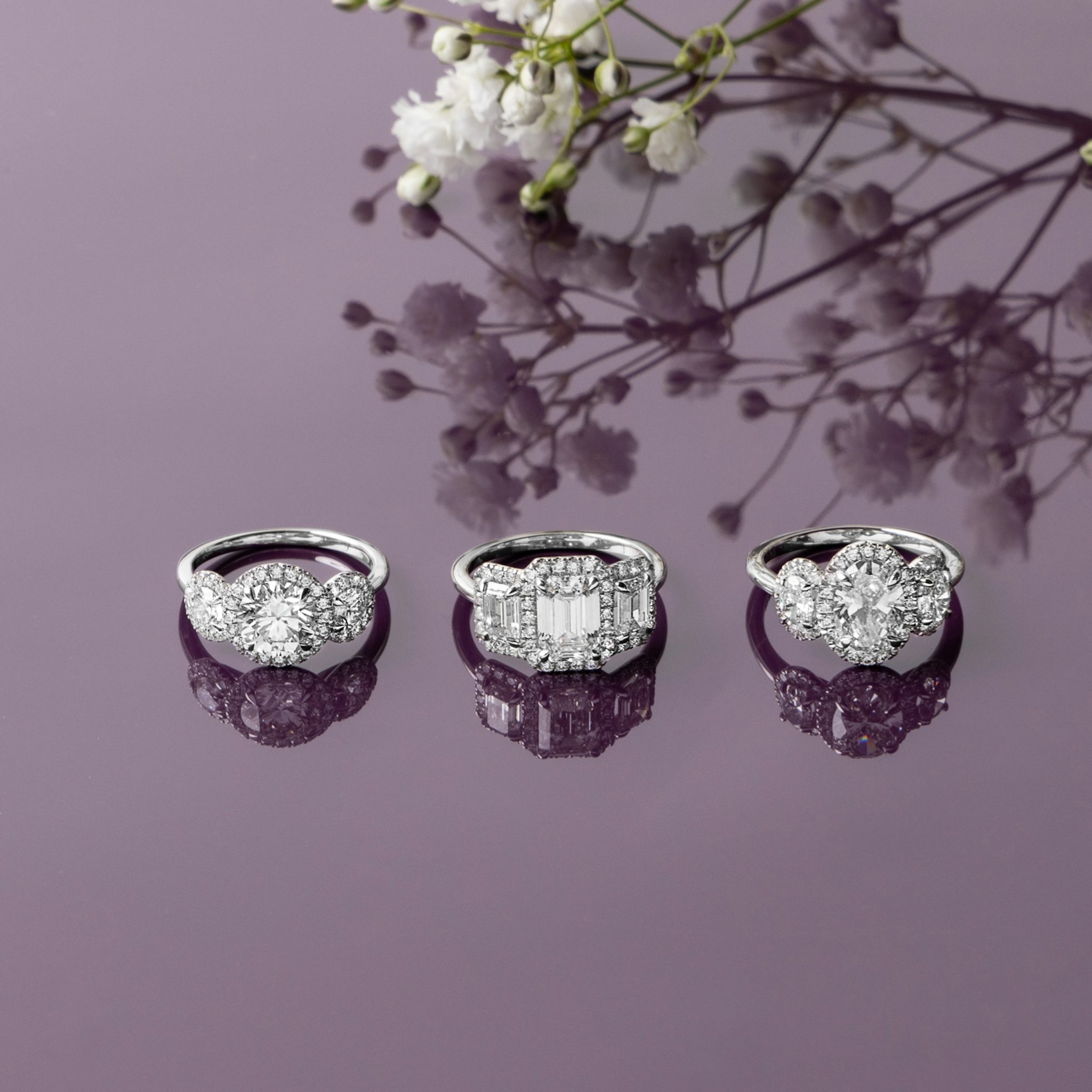 The Three Stone Halo | Oval | Platinum | bandAccent: Plain | sideStoneCarat: 0.25ct | diamondOrientation: vertical | caratWeight: other