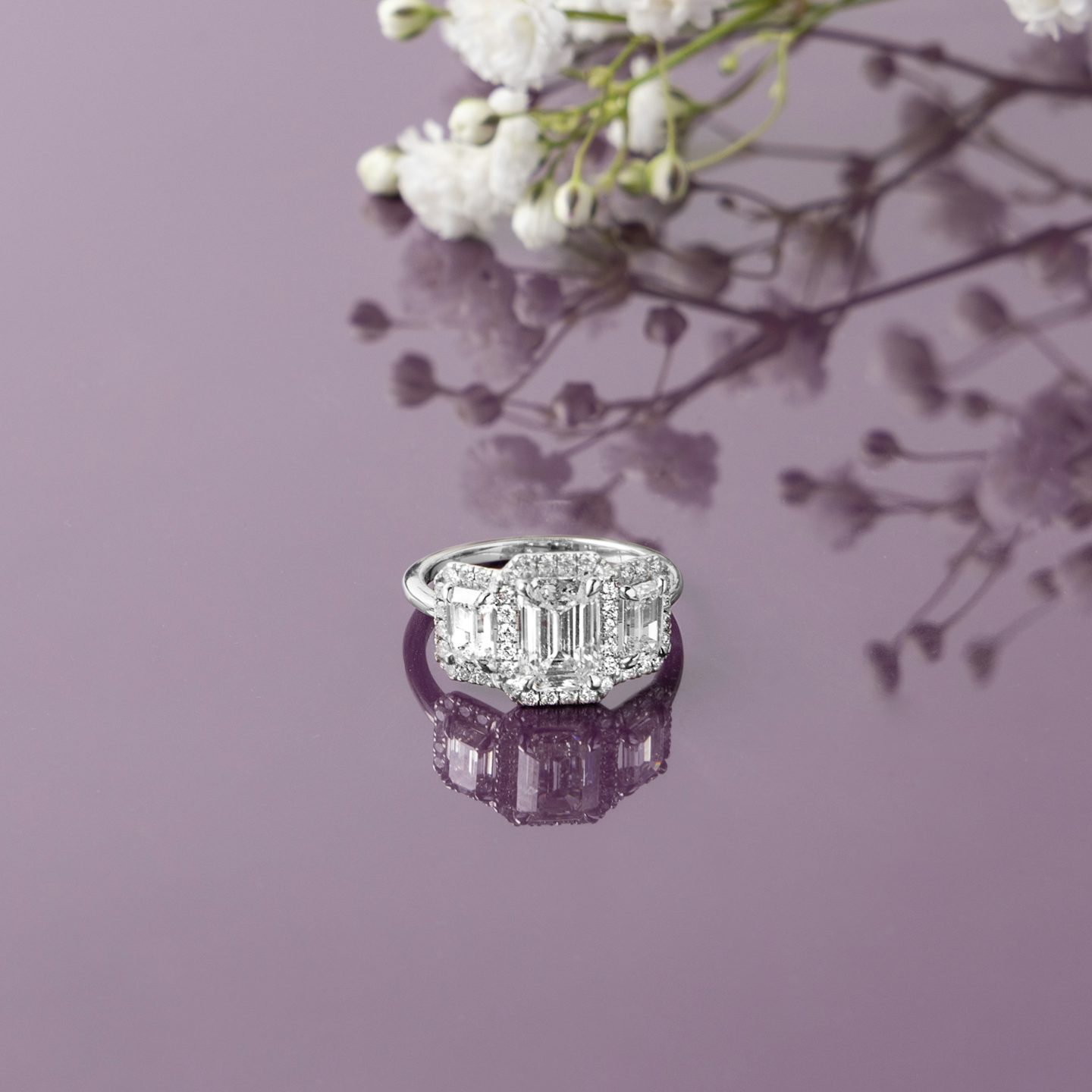 The Three Stone Halo | Emerald | 18k | Yellow Gold | bandAccent: Plain | sideStoneCarat: 0.25ct | diamondOrientation: vertical | caratWeight: other