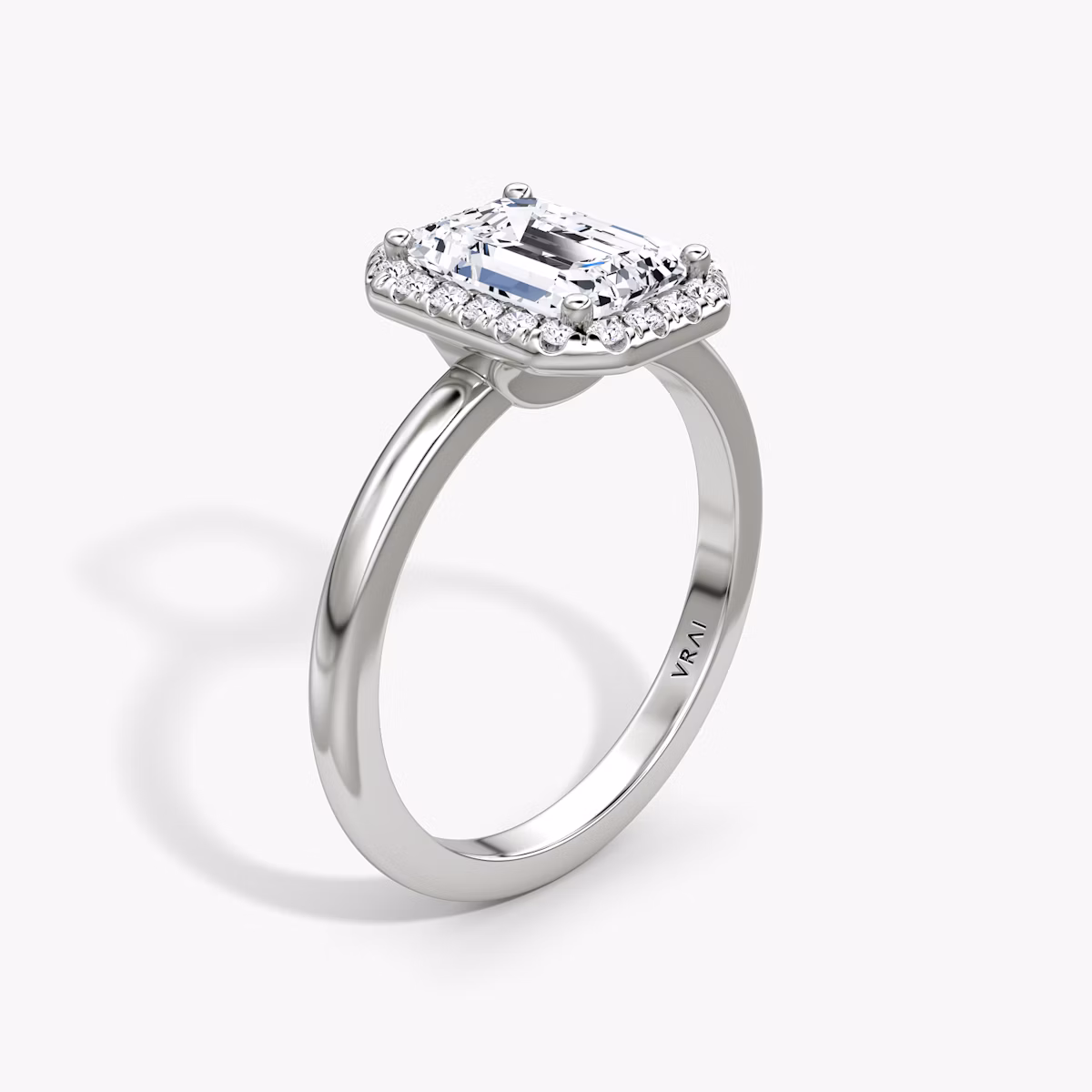The Halo | Emerald | Platinum | bandAccent: Plain | haloSize: original | diamondOrientation: vertical | caratWeight: other