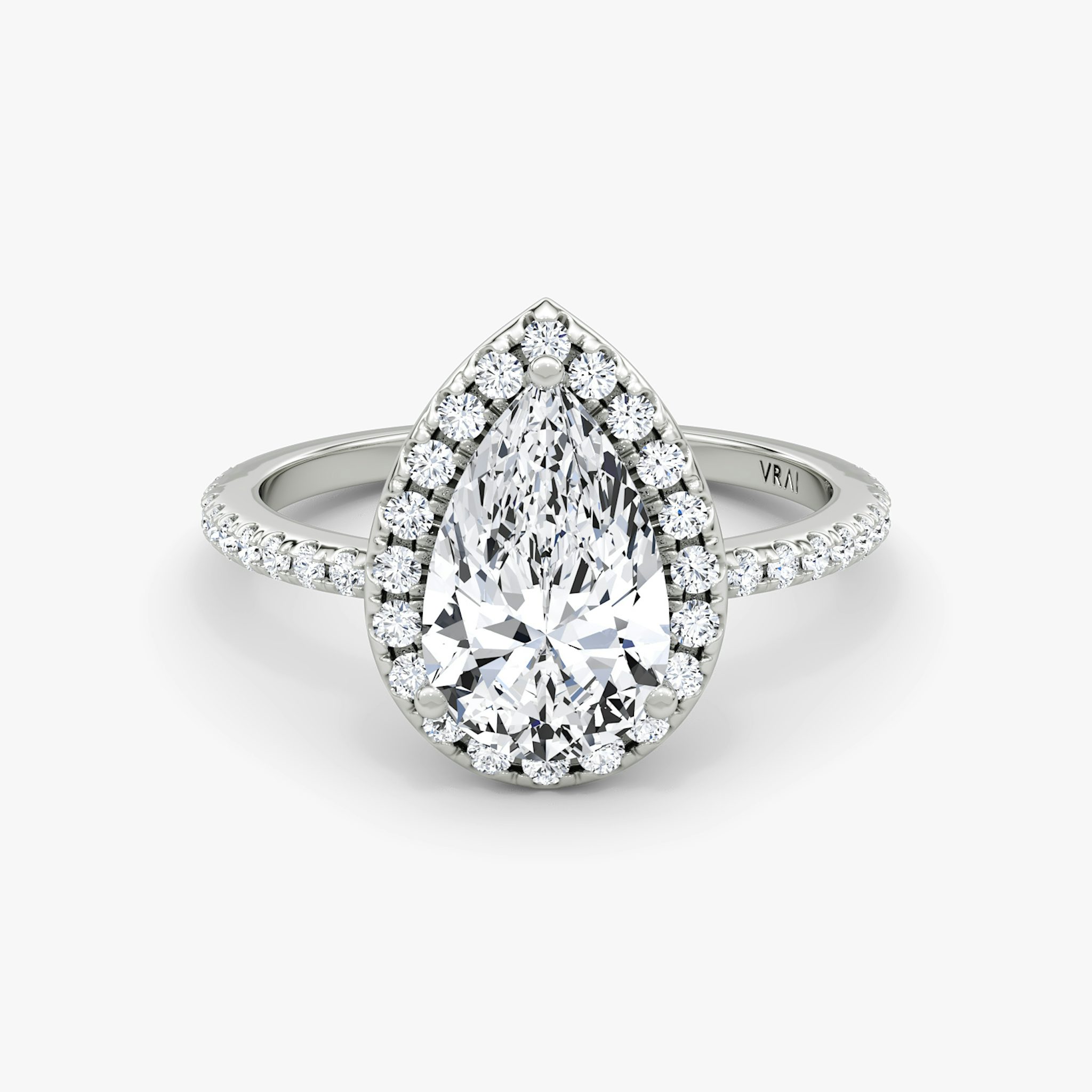 White gold pavé ring with pear-cut center diamond and halo setting, shown on white background.