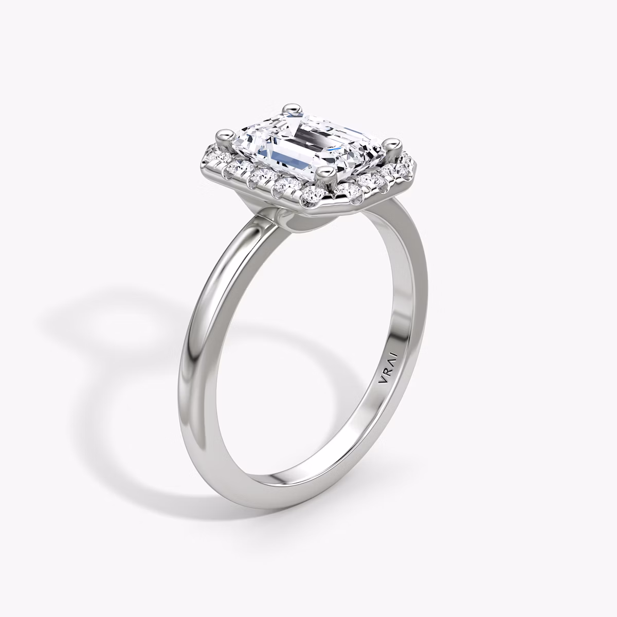 The Halo | Emerald | Platinum | bandAccent: Plain | haloSize: large | diamondOrientation: vertical | caratWeight: other