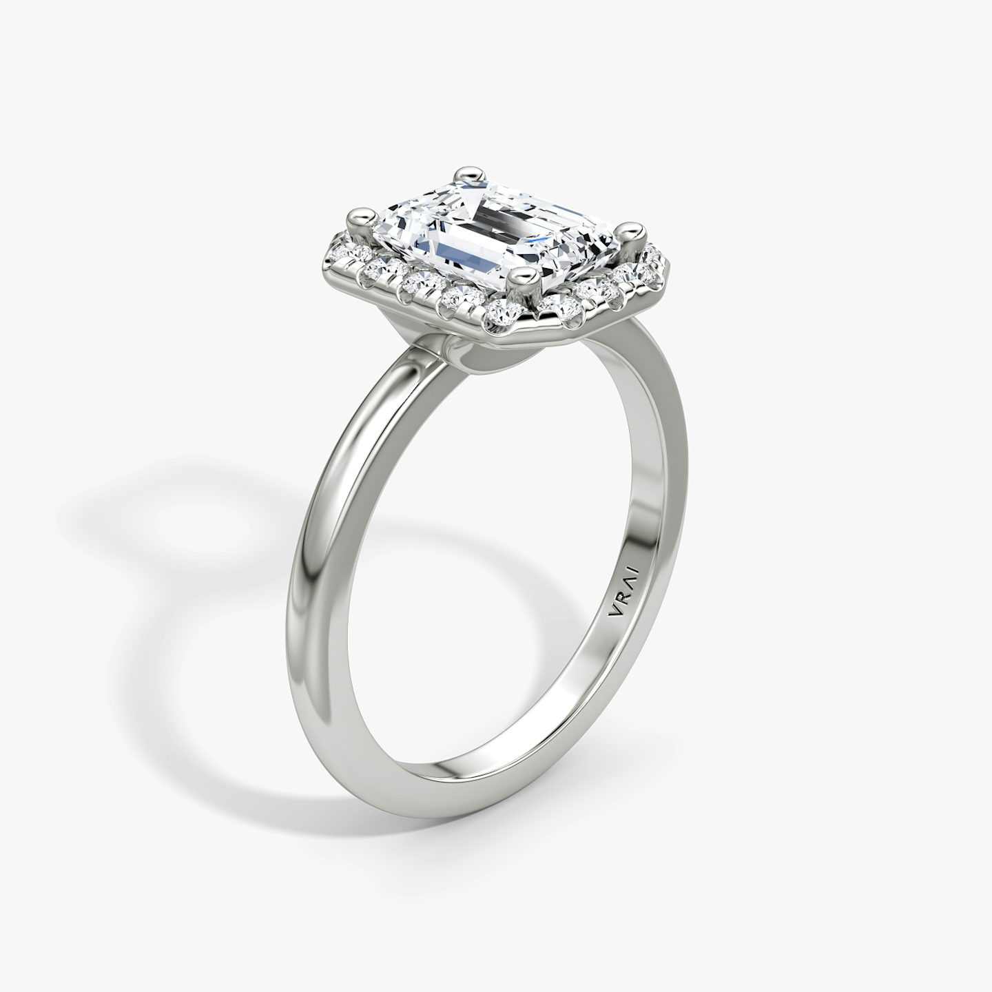 The Halo | Emerald | Platinum | bandAccent: Plain | haloSize: large | diamondOrientation: vertical | caratWeight: other