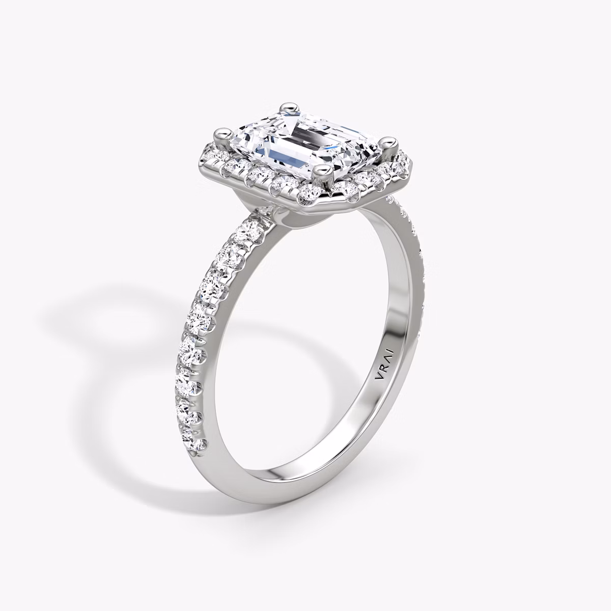 The Halo | Emerald | Platinum | bandAccent: Pavé | haloSize: large | diamondOrientation: vertical | caratWeight: other