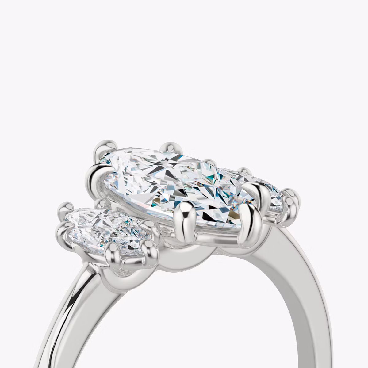 The Three Stone | Marquise | Platinum | bandAccent: Plain | sideStoneCarat: 0.25ct | sideStoneShape: Marquise | diamondOrientation: vertical | caratWeight: other
