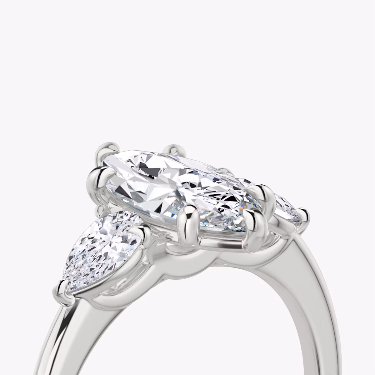 The Three Stone | Marquise | Platinum | bandAccent: Plain | sideStoneCarat: 0.25ct | sideStoneShape: Pear | diamondOrientation: vertical | caratWeight: other