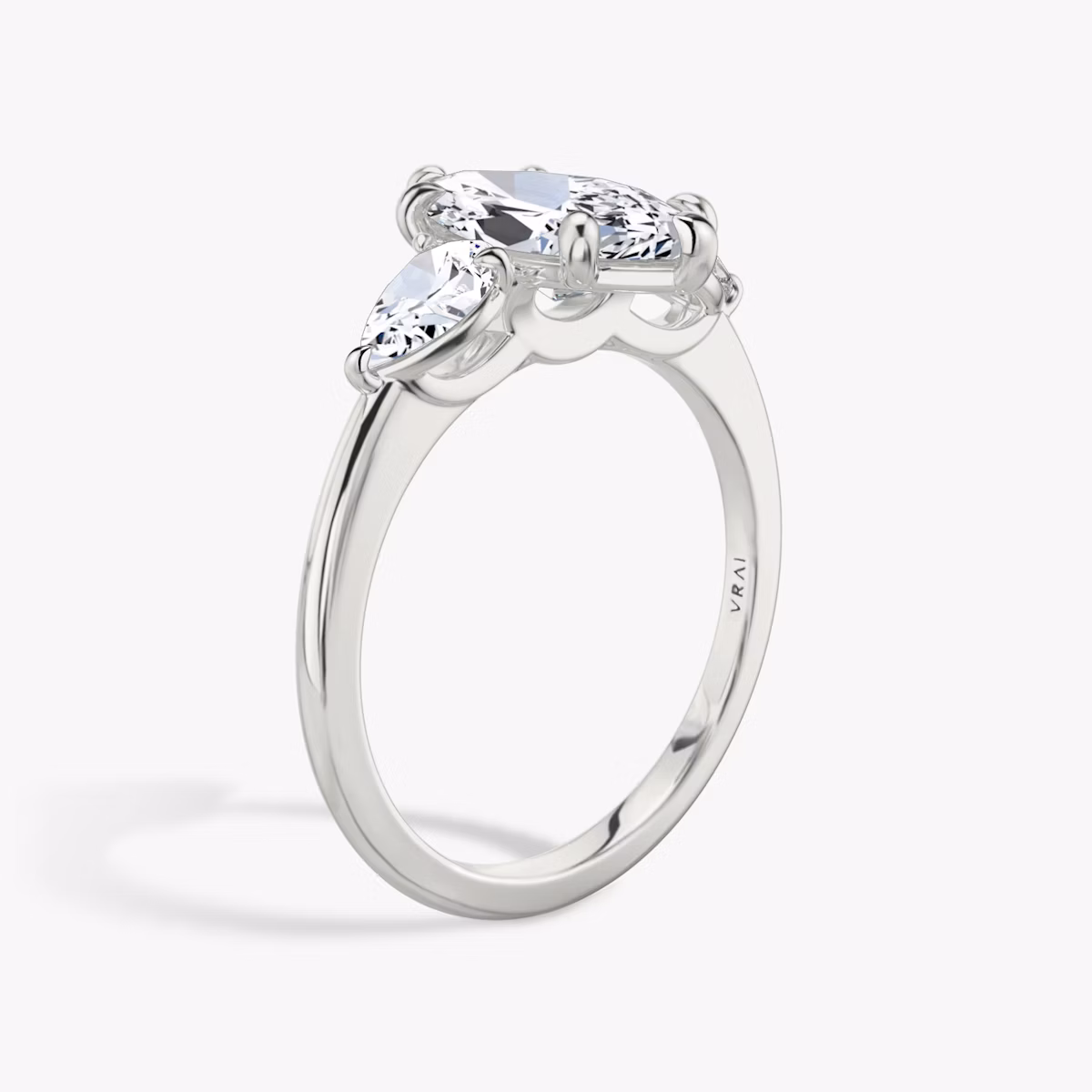 The Three Stone | Marquise | Platinum | bandAccent: Plain | sideStoneCarat: 0.25ct | sideStoneShape: Pear | diamondOrientation: vertical | caratWeight: other