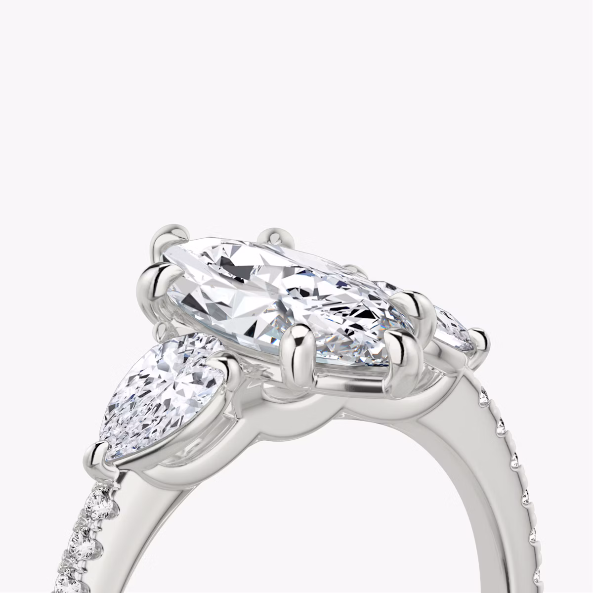 The Three Stone | Marquise | Platinum | bandAccent: Pavé | sideStoneCarat: 0.25ct | sideStoneShape: Pear | diamondOrientation: vertical | caratWeight: other