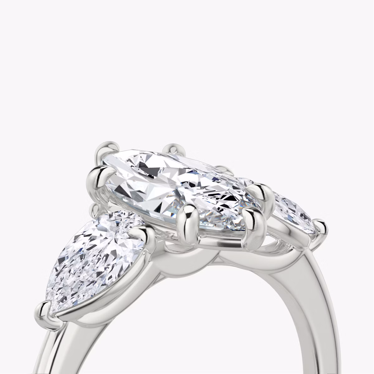 The Three Stone | Marquise | Platinum | bandAccent: Plain | sideStoneCarat: 0.50ct | sideStoneShape: Pear | diamondOrientation: vertical | caratWeight: other