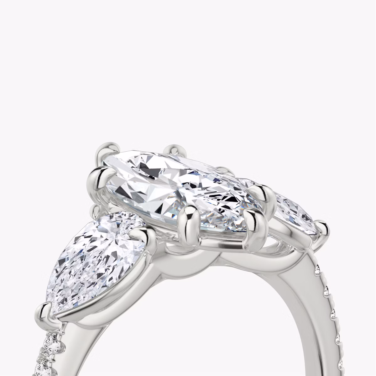 The Three Stone | Marquise | Platinum | bandAccent: Pavé | sideStoneCarat: 0.50ct | sideStoneShape: Pear | diamondOrientation: vertical | caratWeight: other