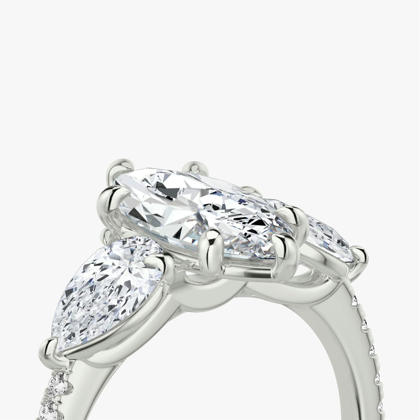 The Three Stone | Marquise | Platinum | bandAccent: Pavé | sideStoneCarat: 0.50ct | sideStoneShape: Pear | diamondOrientation: vertical | caratWeight: other