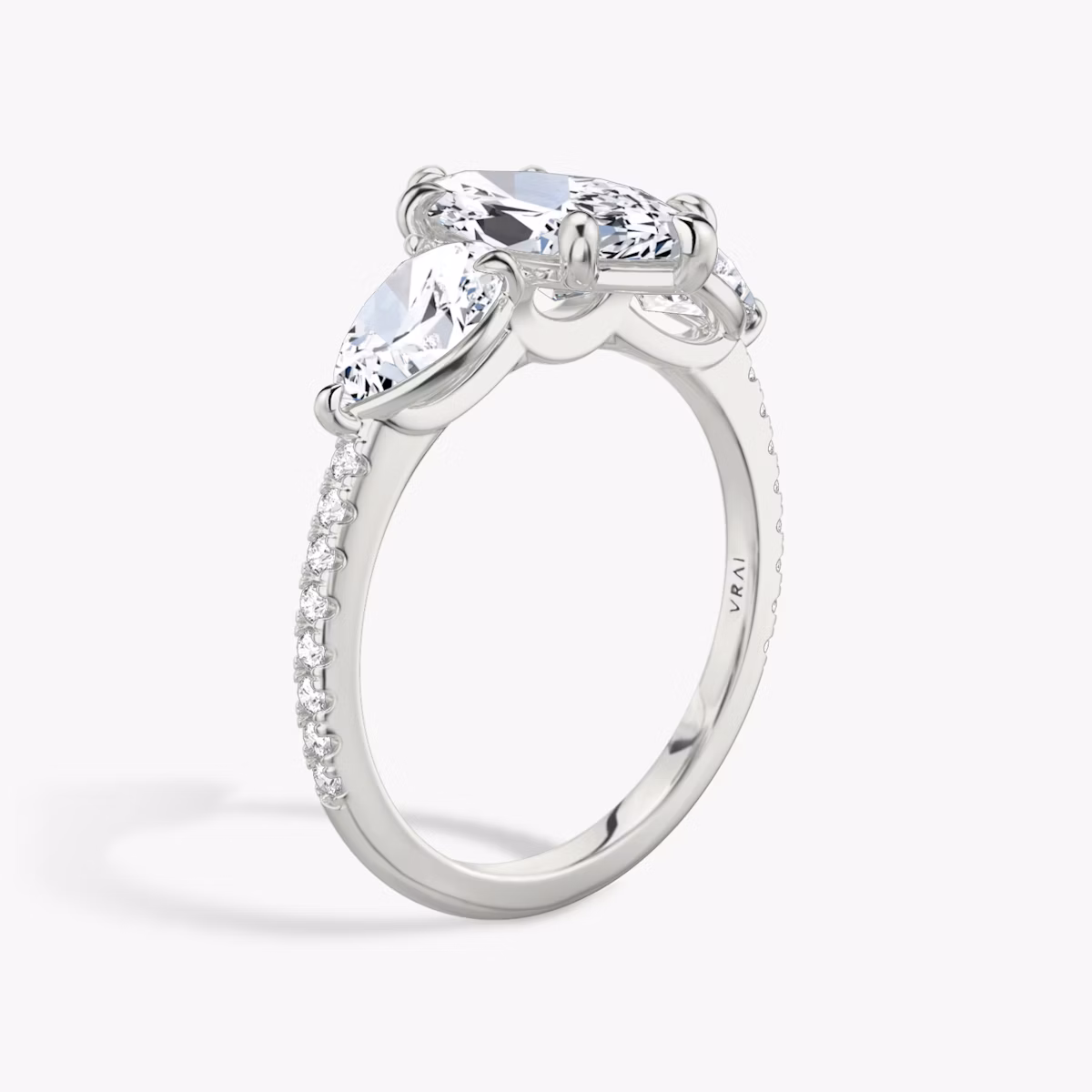 The Three Stone | Marquise | Platinum | bandAccent: Pavé | sideStoneCarat: 0.50ct | sideStoneShape: Pear | diamondOrientation: vertical | caratWeight: other