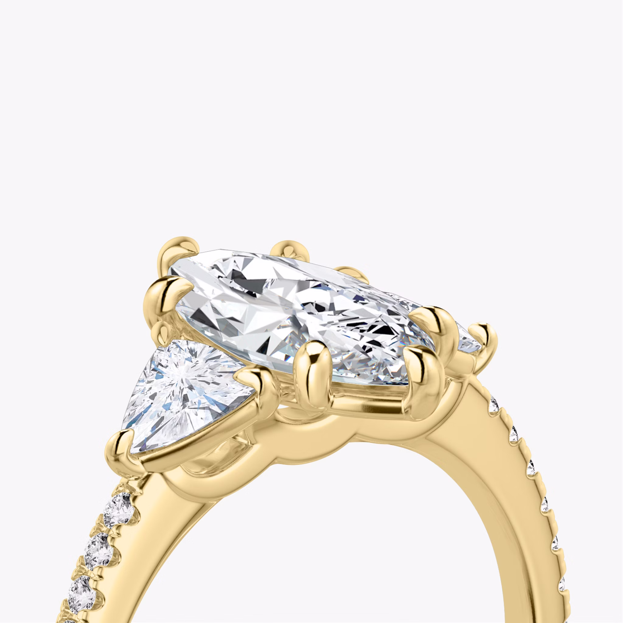 The Three Stone | Marquise | 18k | Yellow Gold | bandAccent: Pavé | sideStoneCarat: 0.25ct | sideStoneShape: Trillion | diamondOrientation: vertical | caratWeight: other