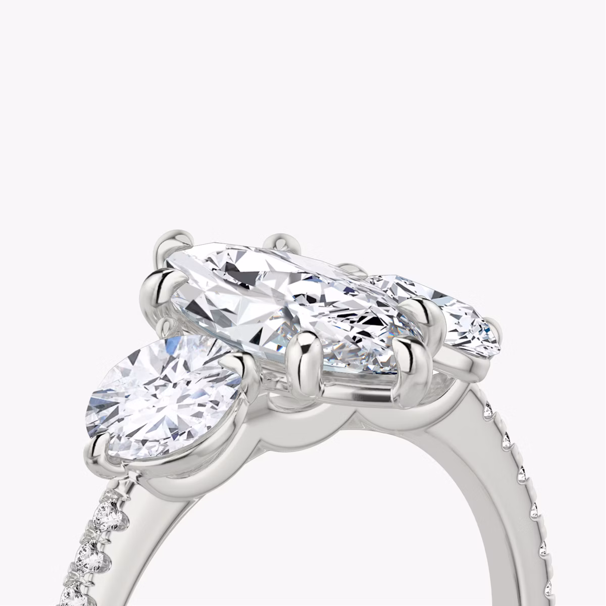 The Three Stone | Marquise | Platinum | bandAccent: Pavé | sideStoneCarat: 0.50ct | sideStoneShape: Round Brilliant | diamondOrientation: vertical | caratWeight: other