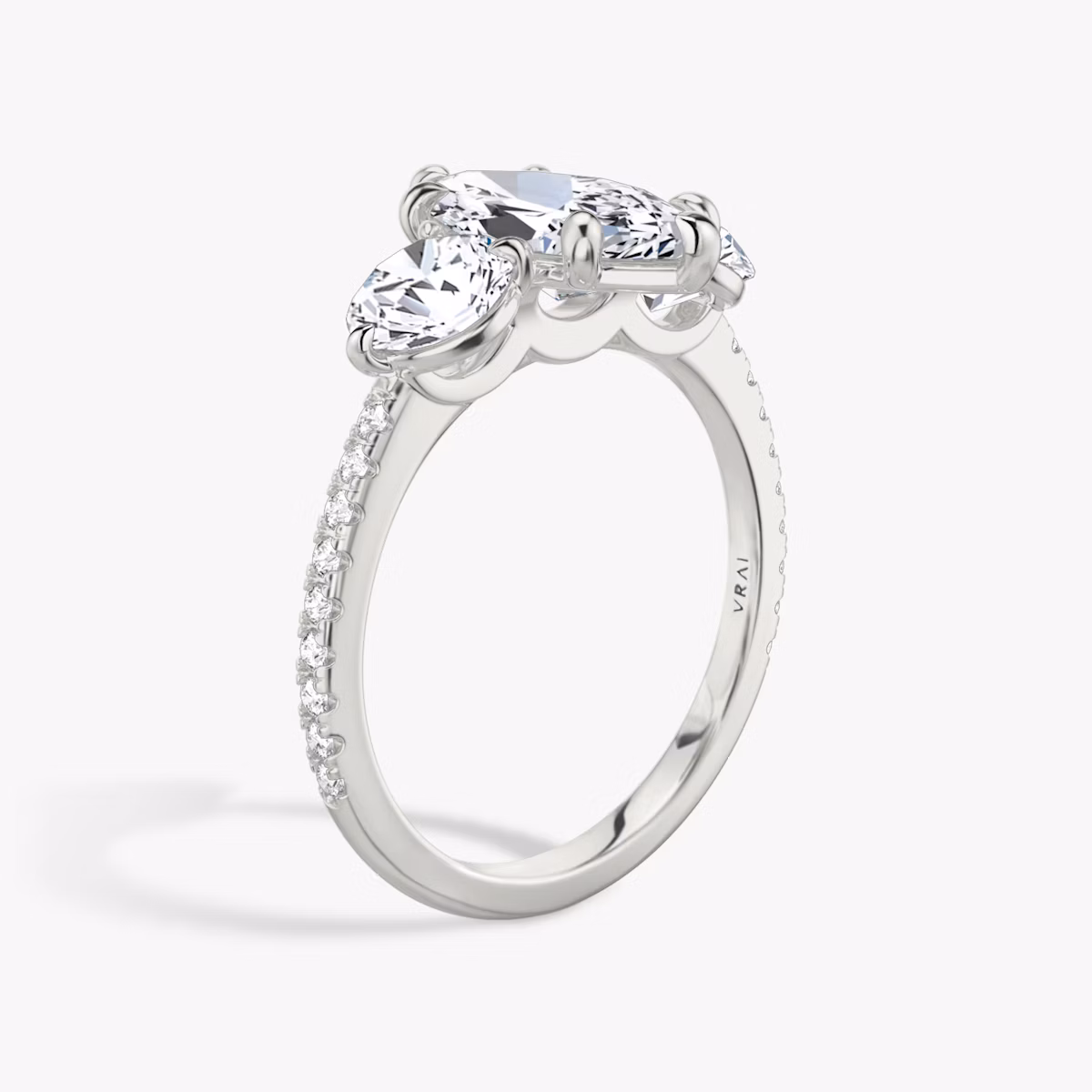 The Three Stone | Marquise | Platinum | bandAccent: Pavé | sideStoneCarat: 0.50ct | sideStoneShape: Round Brilliant | diamondOrientation: vertical | caratWeight: other