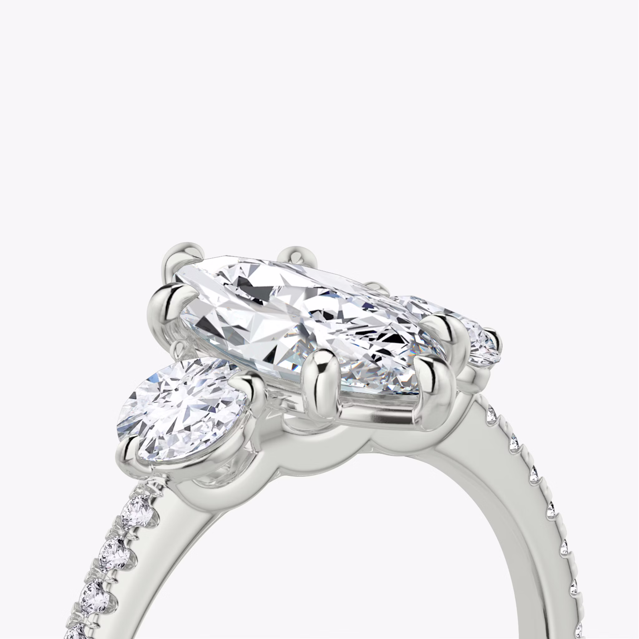 The Three Stone | Marquise | 18k | White Gold | bandAccent: Pavé | sideStoneCarat: 0.25ct | sideStoneShape: Round Brilliant | diamondOrientation: vertical | caratWeight: other